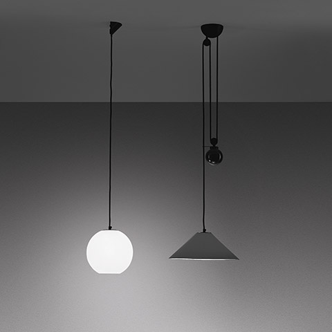 Two Artemide Aggregato pendant lamps: left opal white spherical glass globe, right dark conical shade with pulley system on black cords