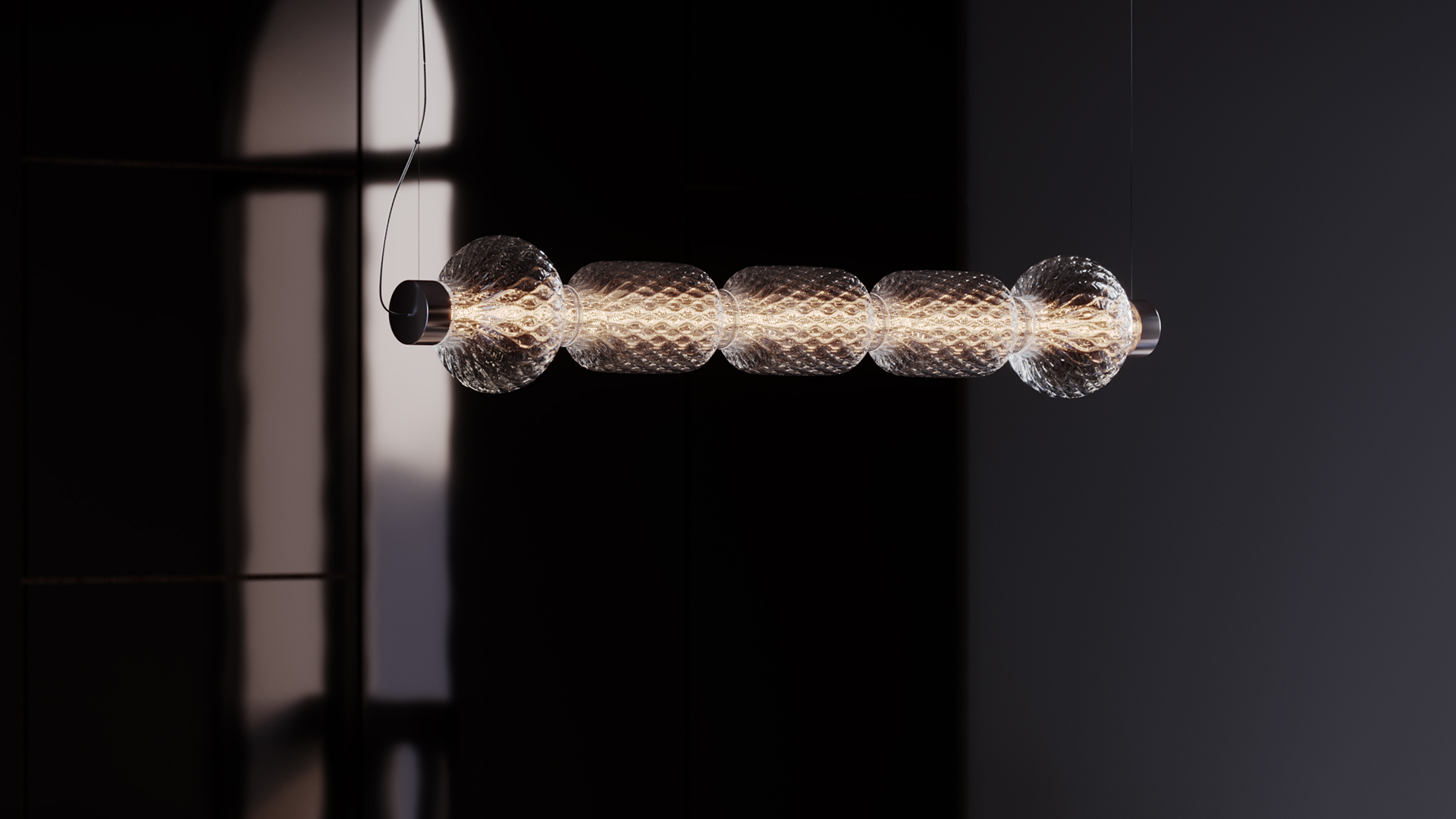 Artemide Alambicco pendant lamp: horizontal metal tube with five spherical clear glass diffusers, warm LED light, suspended by black cord