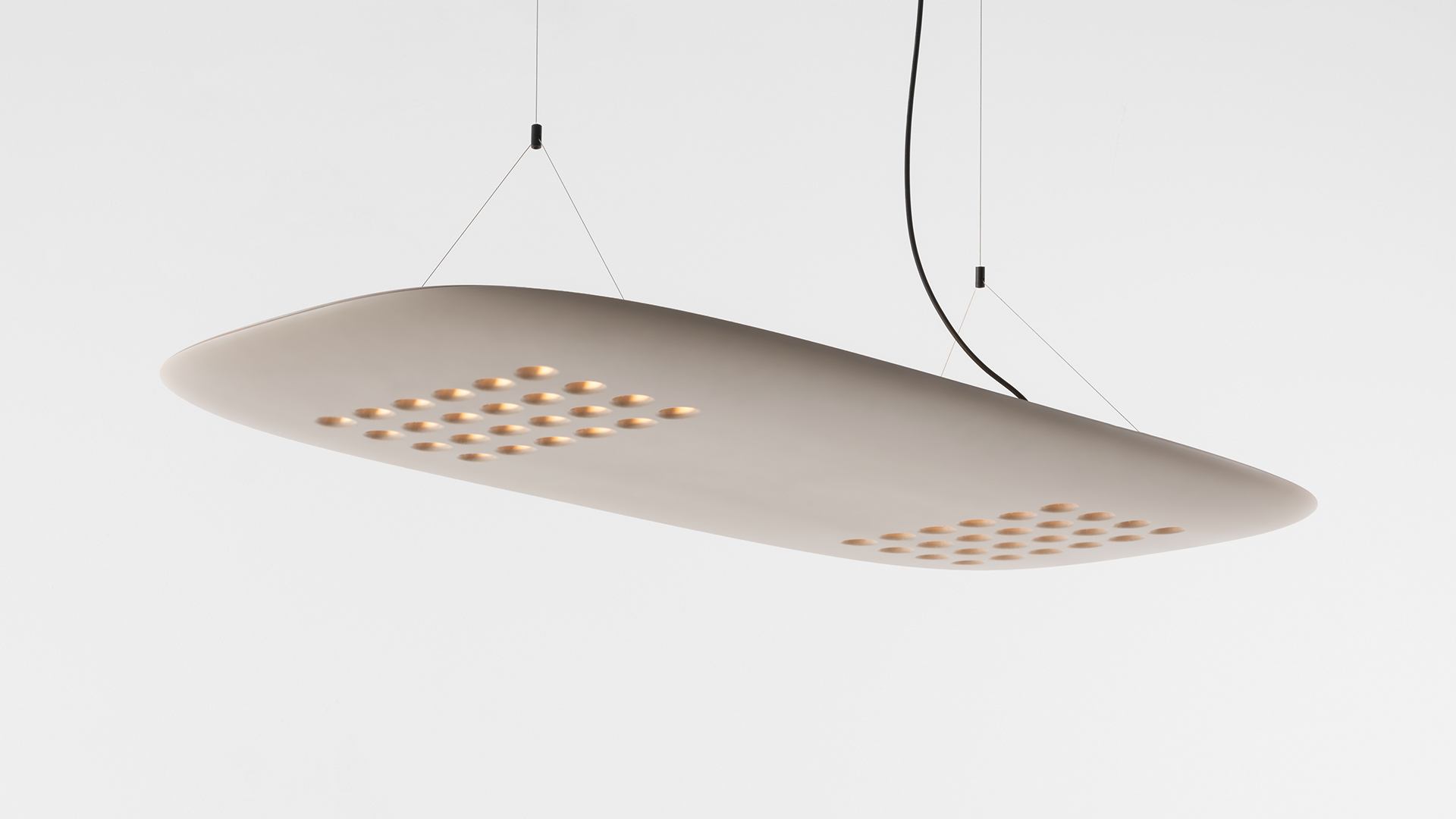 Artemide ALE.01 oval pendant lamp in warm wood finish illuminating a dark workspace with two black-framed tables below