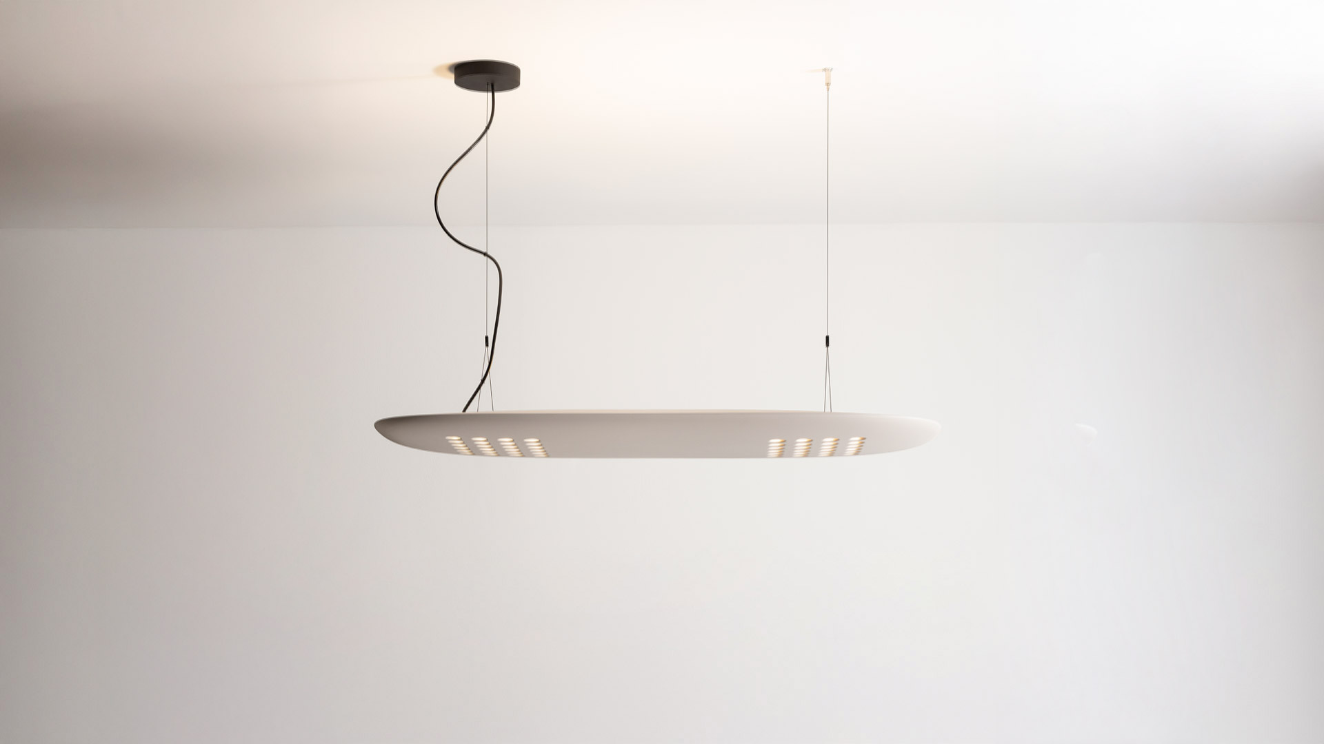 Artemide ALE.01 pendant lamp: large oval grey diffuser with gold LED arrays on underside, suspended by black cable