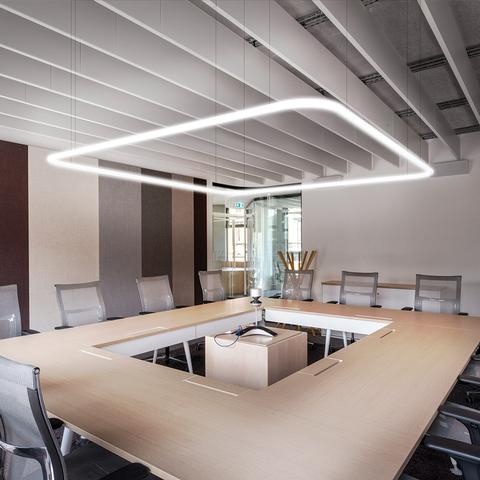 Artemide Alphabet of Light Square pendant illuminates a modern conference room, casting even light over a large wooden meeting table.