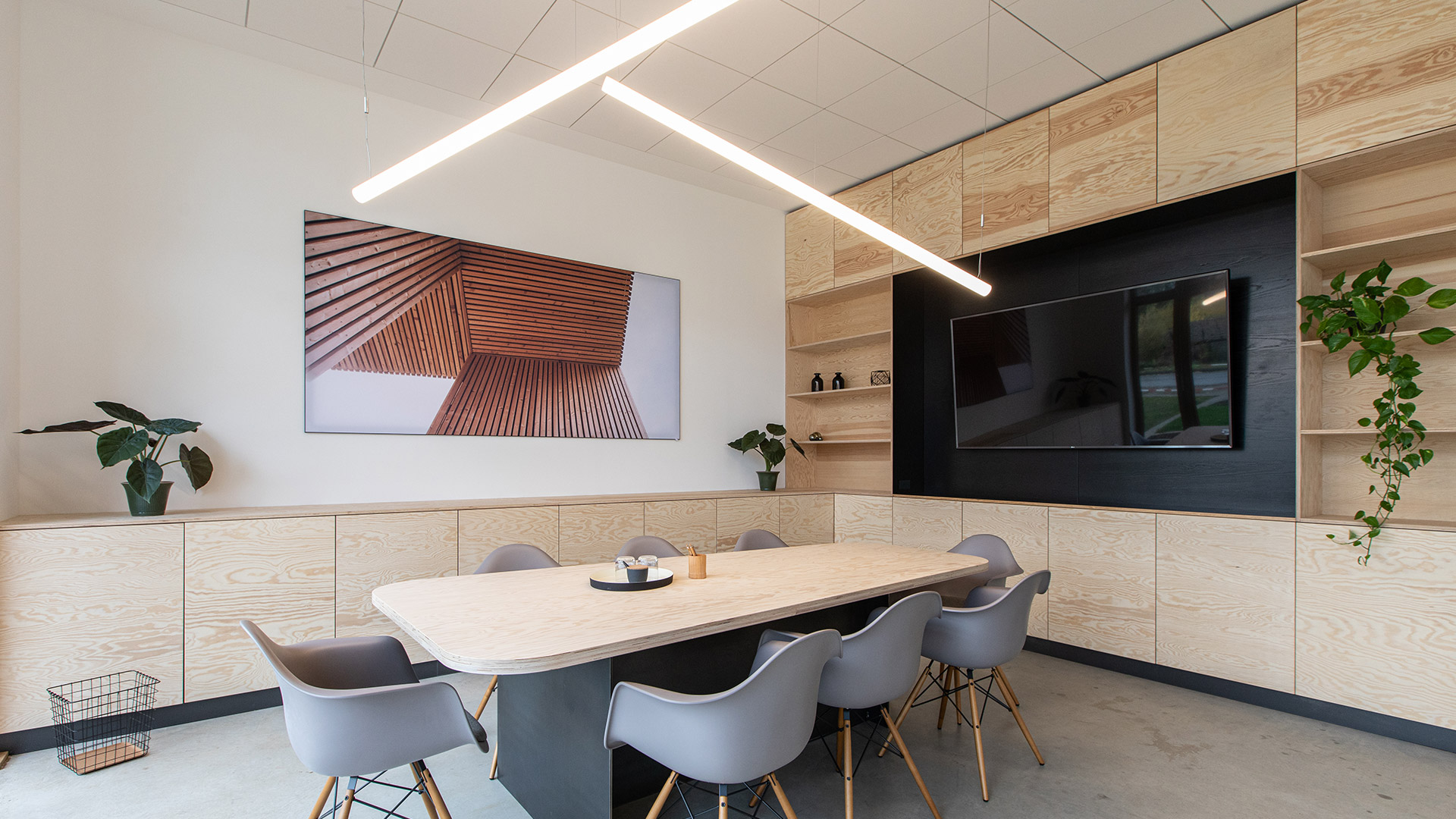 Artemide Alphabet of Light Linear pendant lamp: sleek white cylindrical tube emitting soft diffused light, suspended by black cables