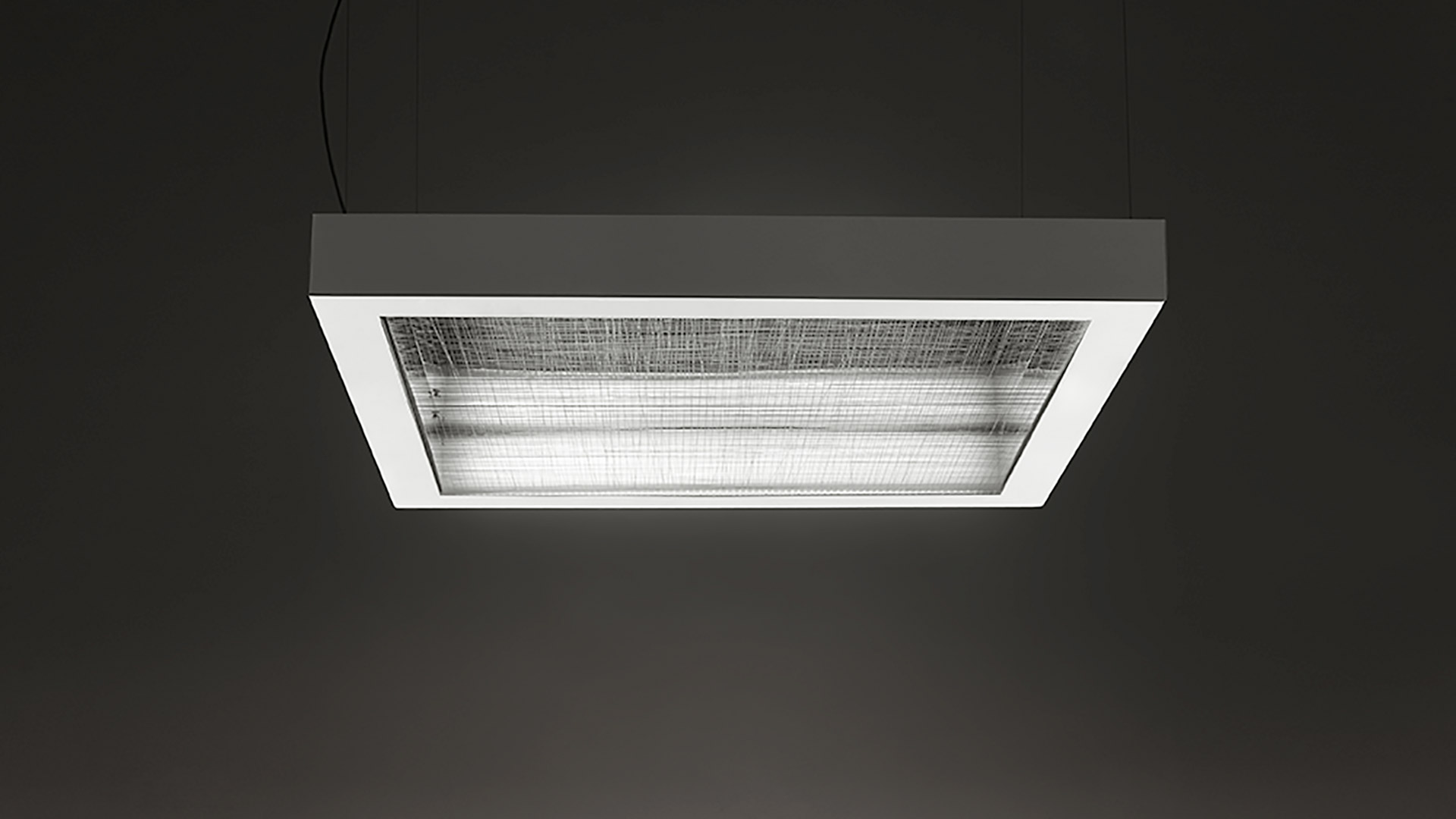 Artemide Altrove pendant lamp: rectangular grey metal frame with white inner border and textured glass diffuser, suspended by cable