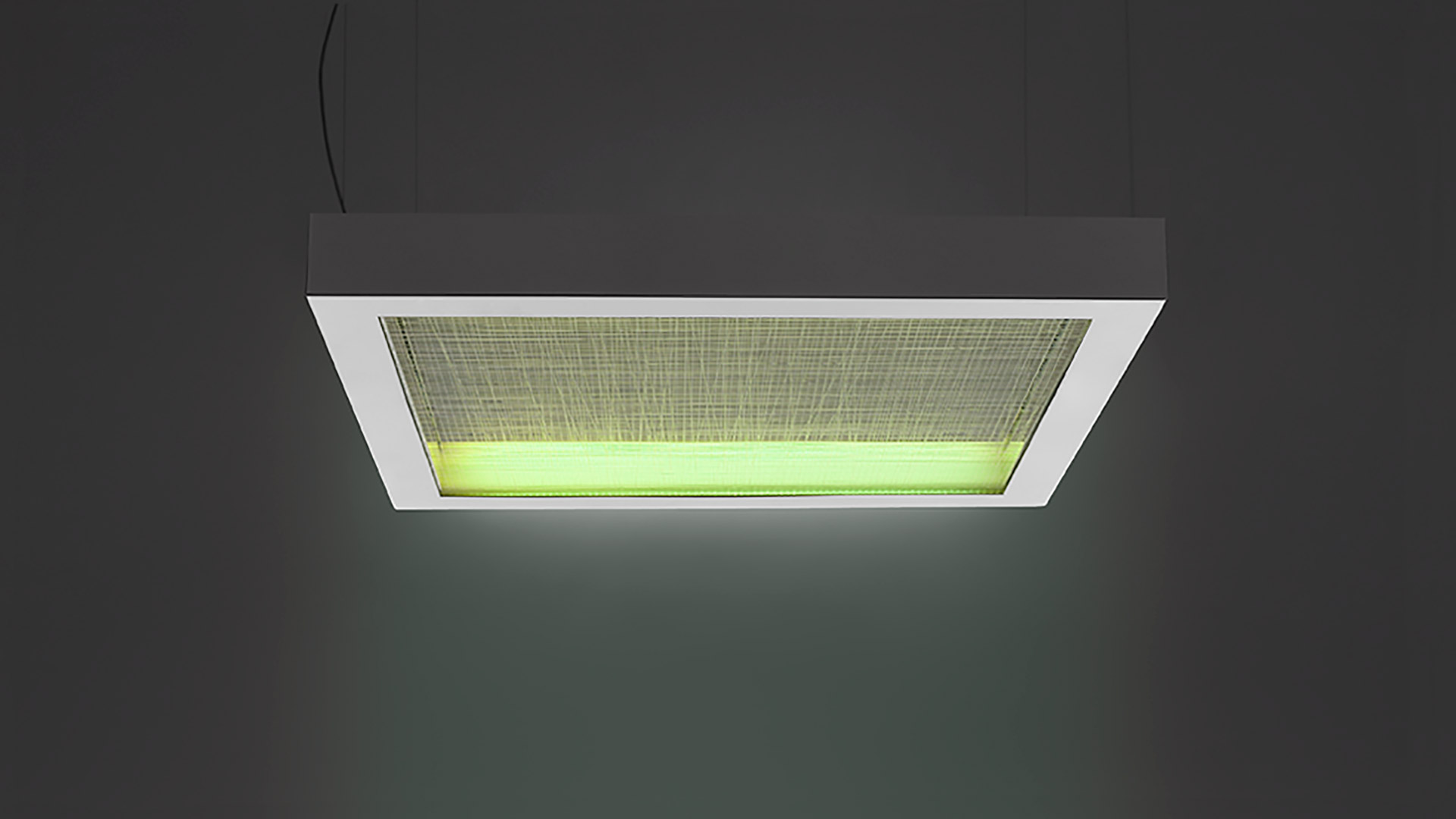 Artemide Altrove pendant lamp: rectangular white frame with green-lit textile diffuser, suspended from ceiling by black cable