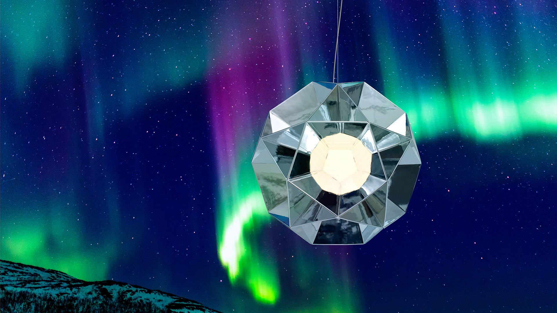 Artemide Arctic pendant lamp with faceted crystal-like diffuser suspended against a night sky with vivid aurora borealis