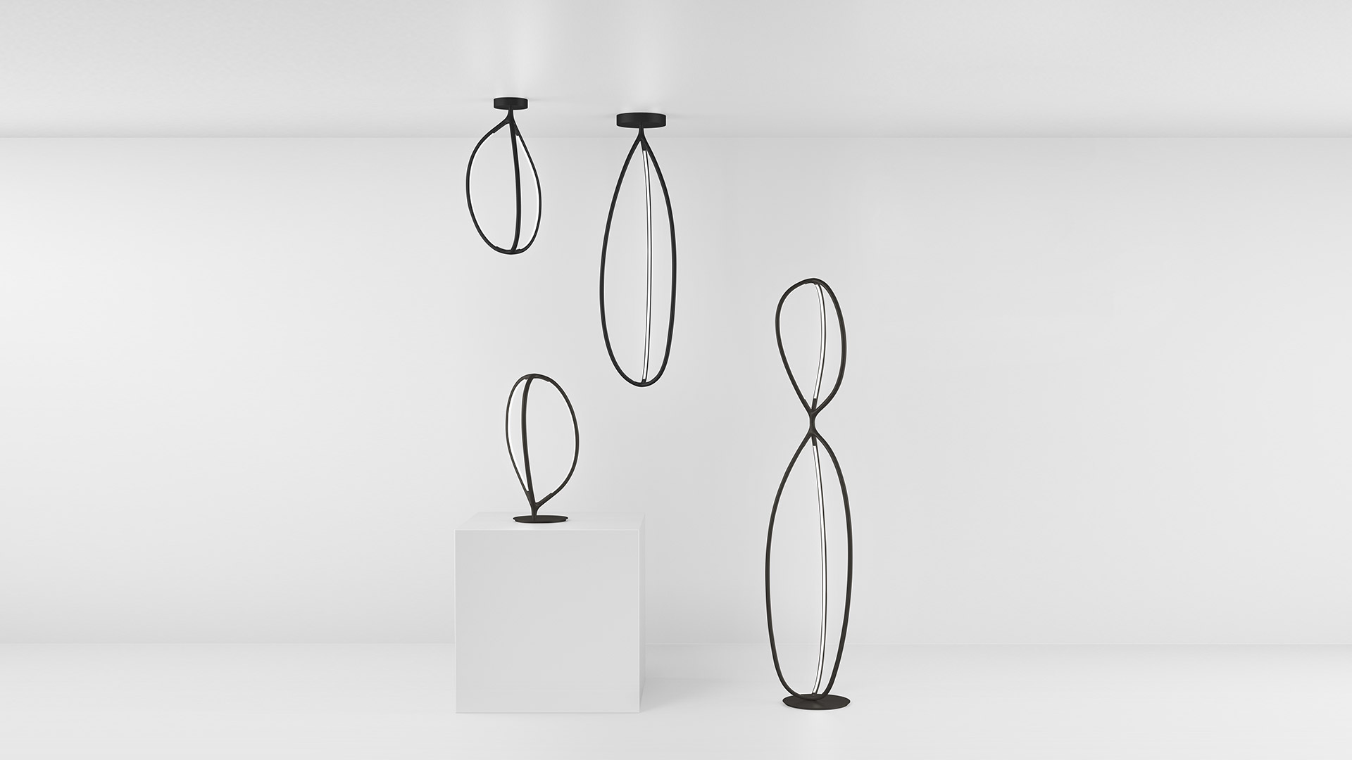 Hand touching the base of Artemide Arrival table lamp, demonstrating touch control on its round black base with branching arms.