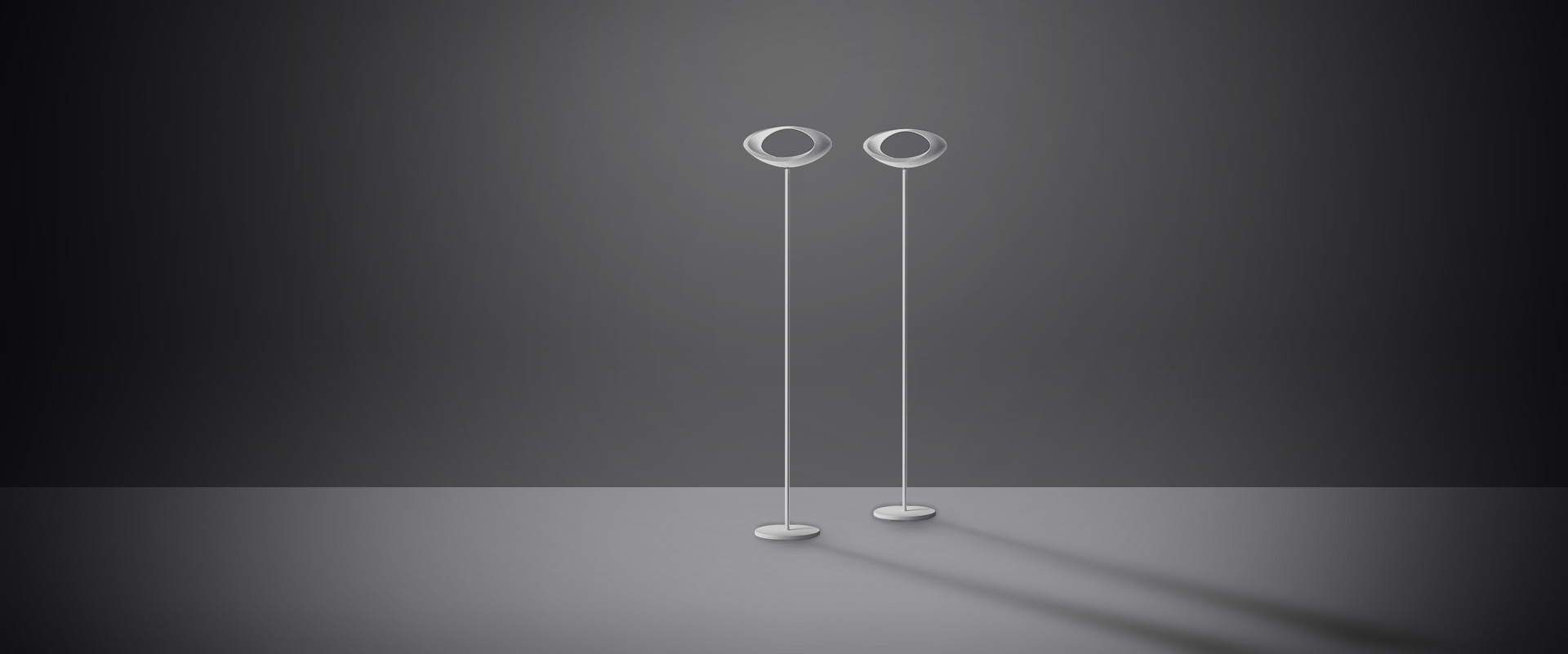 Artemide Cabildo table lamp: white sculptural bowl-shaped diffuser with circular opening, mounted on a slim cylindrical base
