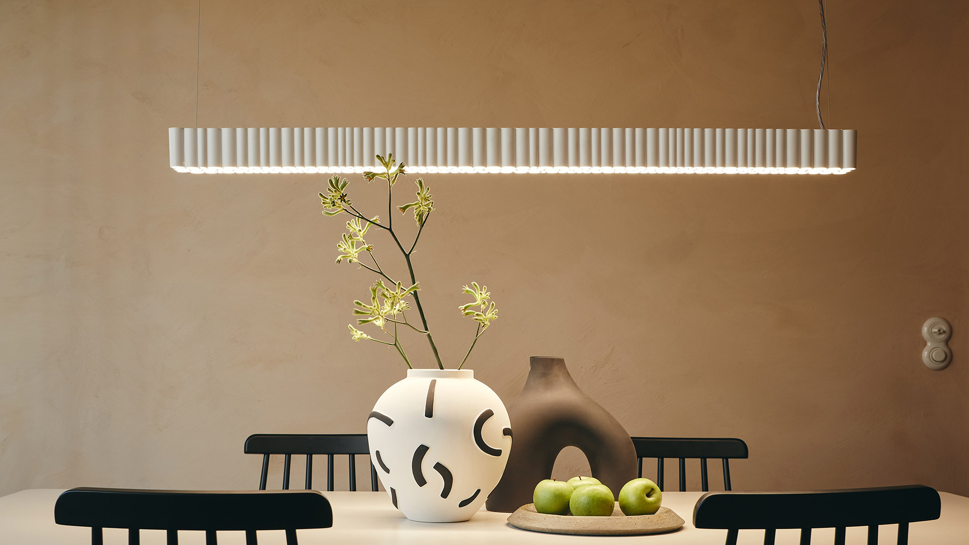 Artemide Calipso Linear Stand Alone pendant lamp: sleek horizontal grey bar with evenly spaced LED modules emitting soft diffused light