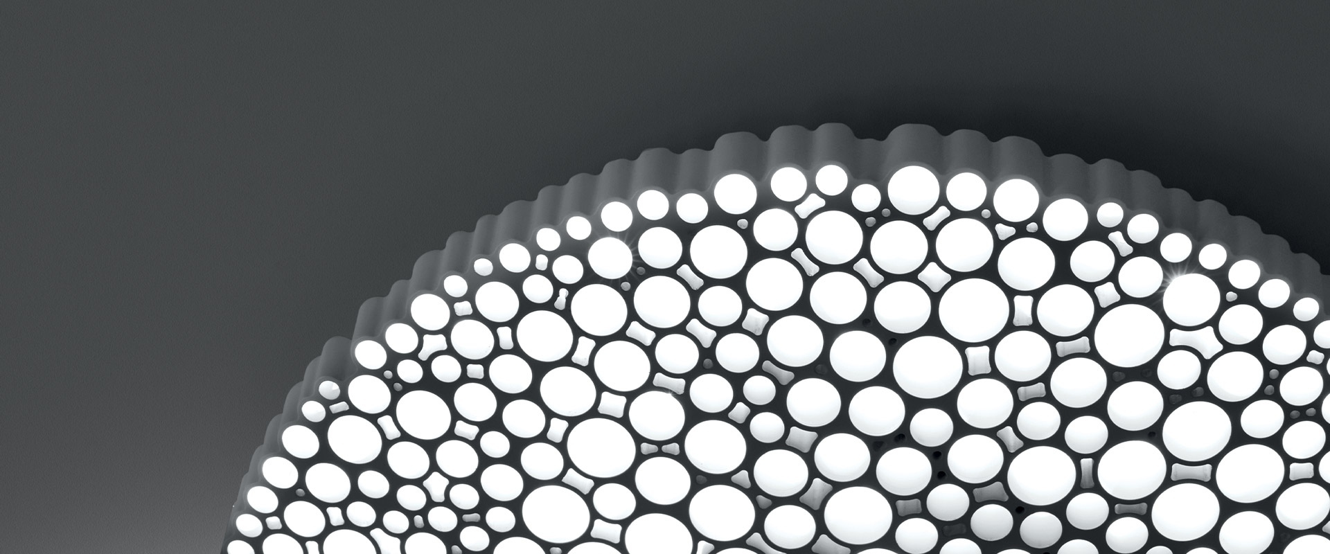 Artemide Calipso ceiling lamp detail: circular diffuser with varying-size round LED light cells arranged in a honeycomb pattern