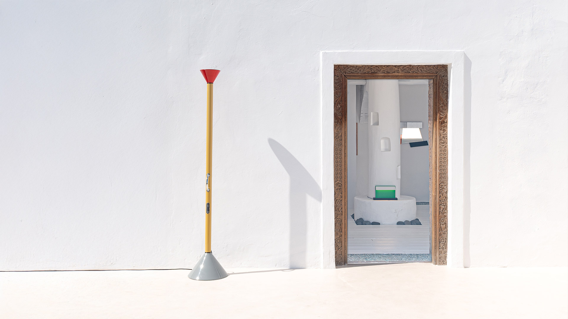 Artemide Callimaco floor lamp: tall yellow stem, red upward cone diffuser on top, grey conical base, with dimmer switch on stem