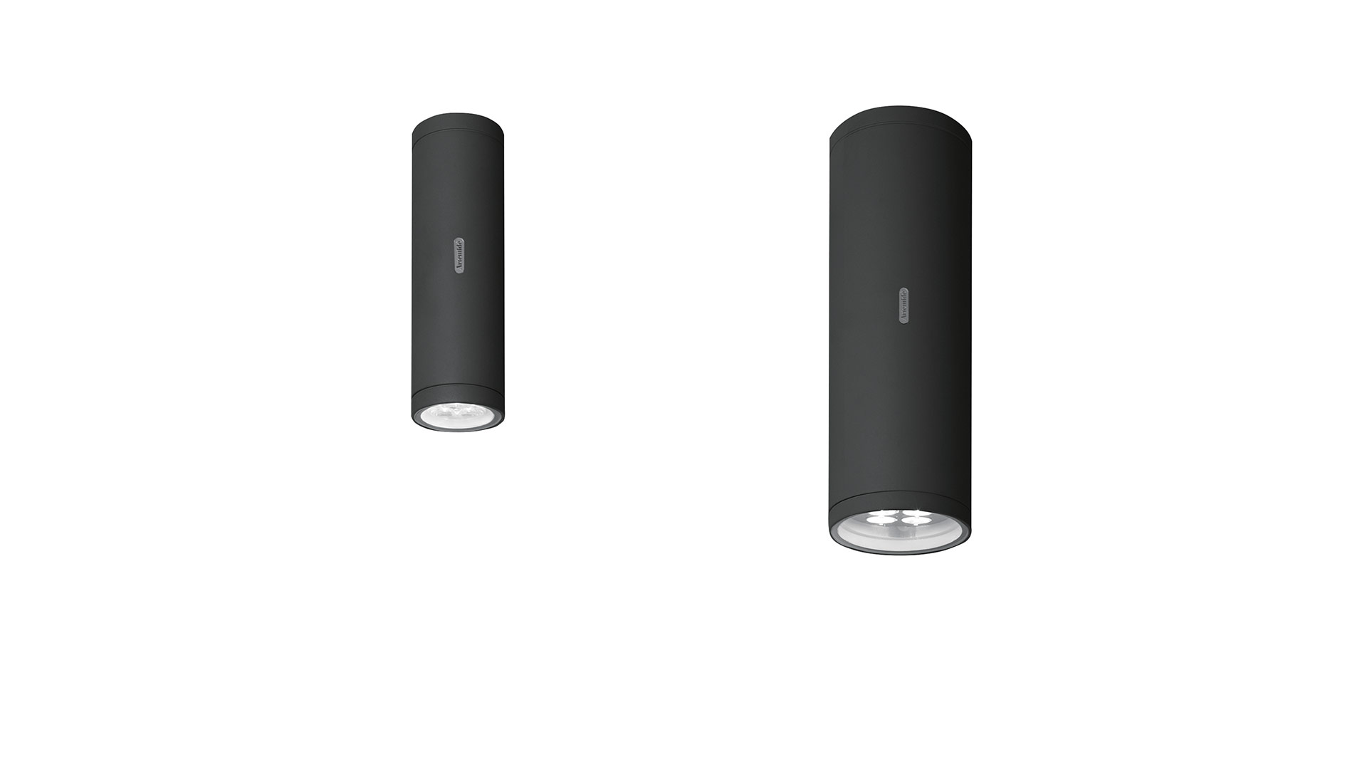 Two Artemide Calumet ceiling spotlights in matte black, cylindrical shape with chrome inner reflector, shown in two sizes