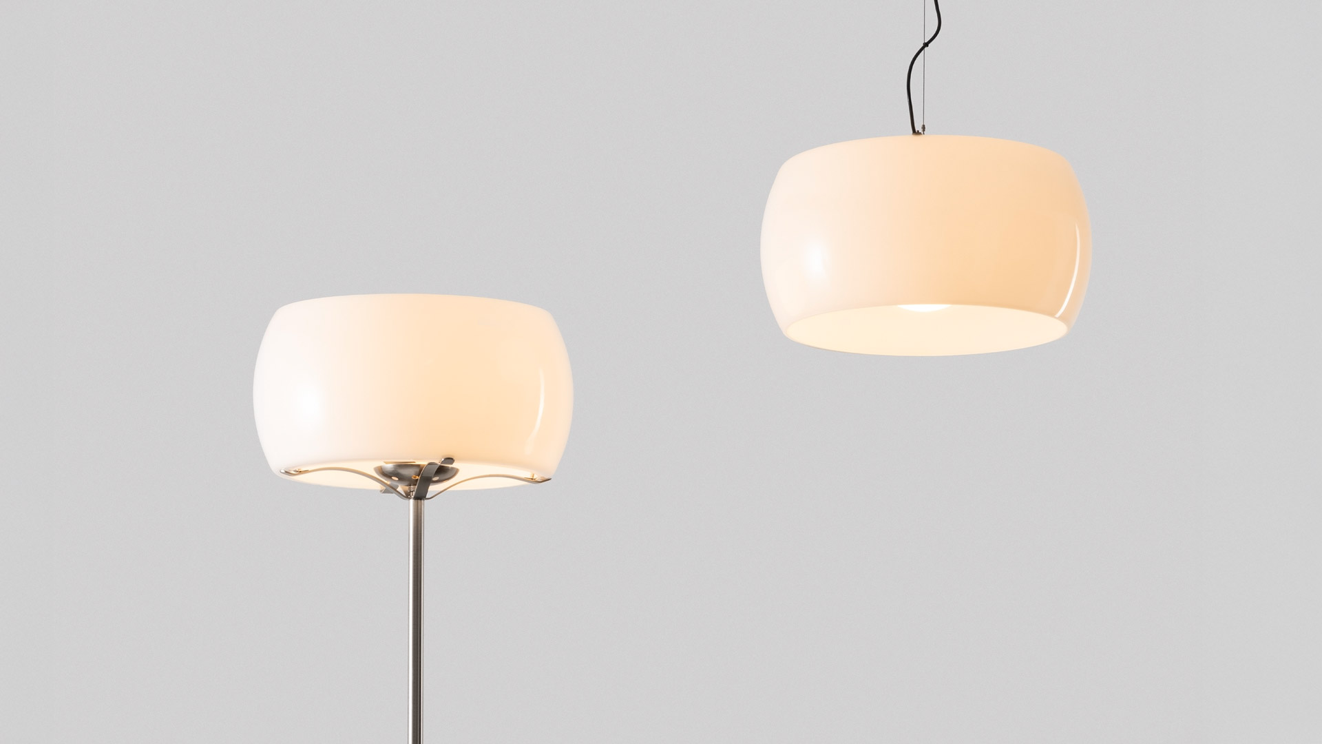 Artemide Clitunno floor lamp with rounded opal white glass shade and polished chrome metal stem on white background
