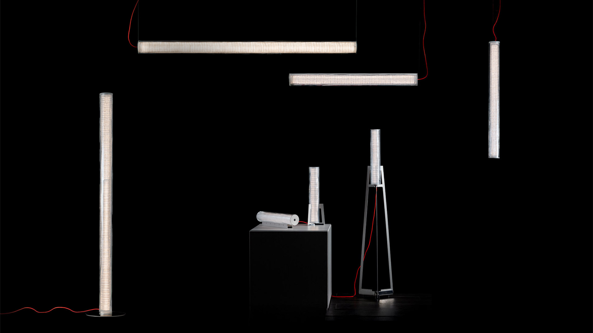 Artemide Criosfera floor lamp with slim tripod base and vertical glowing column, set against an arctic icebergs landscape
