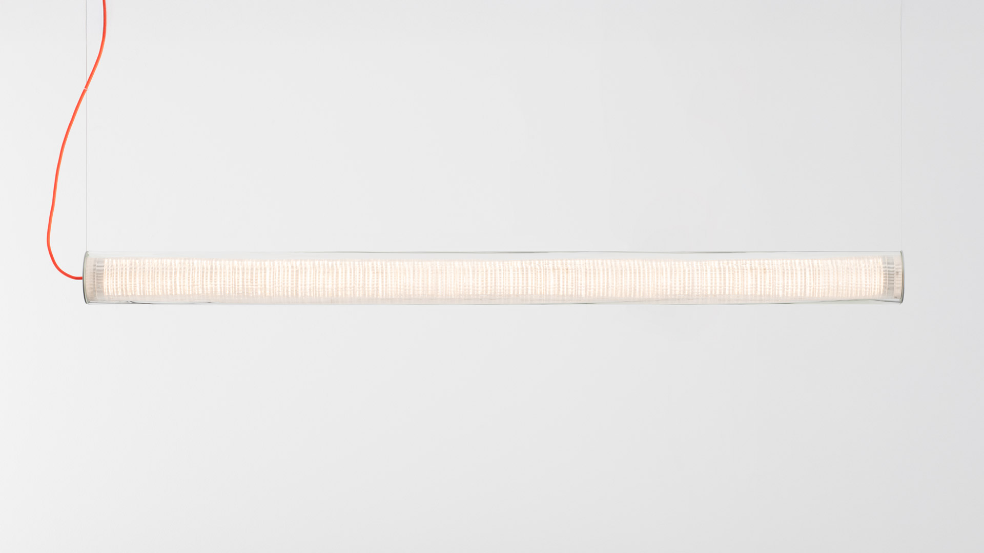 Artemide Criosfera pendant lamp: cylindrical woven diffuser with metallic end cap and distinctive curved red power cord