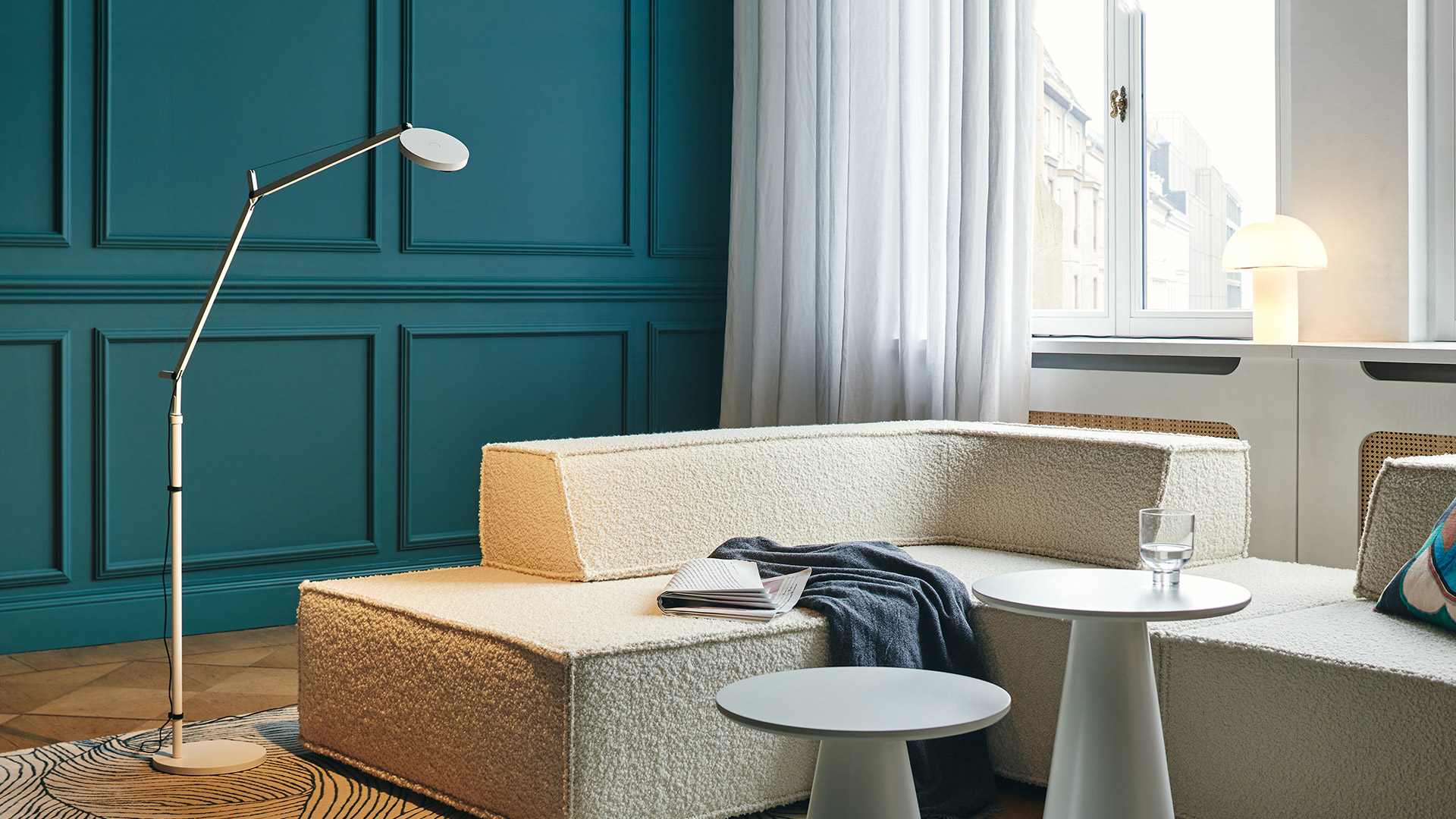 Artemide Demetra Reading Floor lamp in black, adjustable articulated arm with circular LED head, shown with multiple position shadow