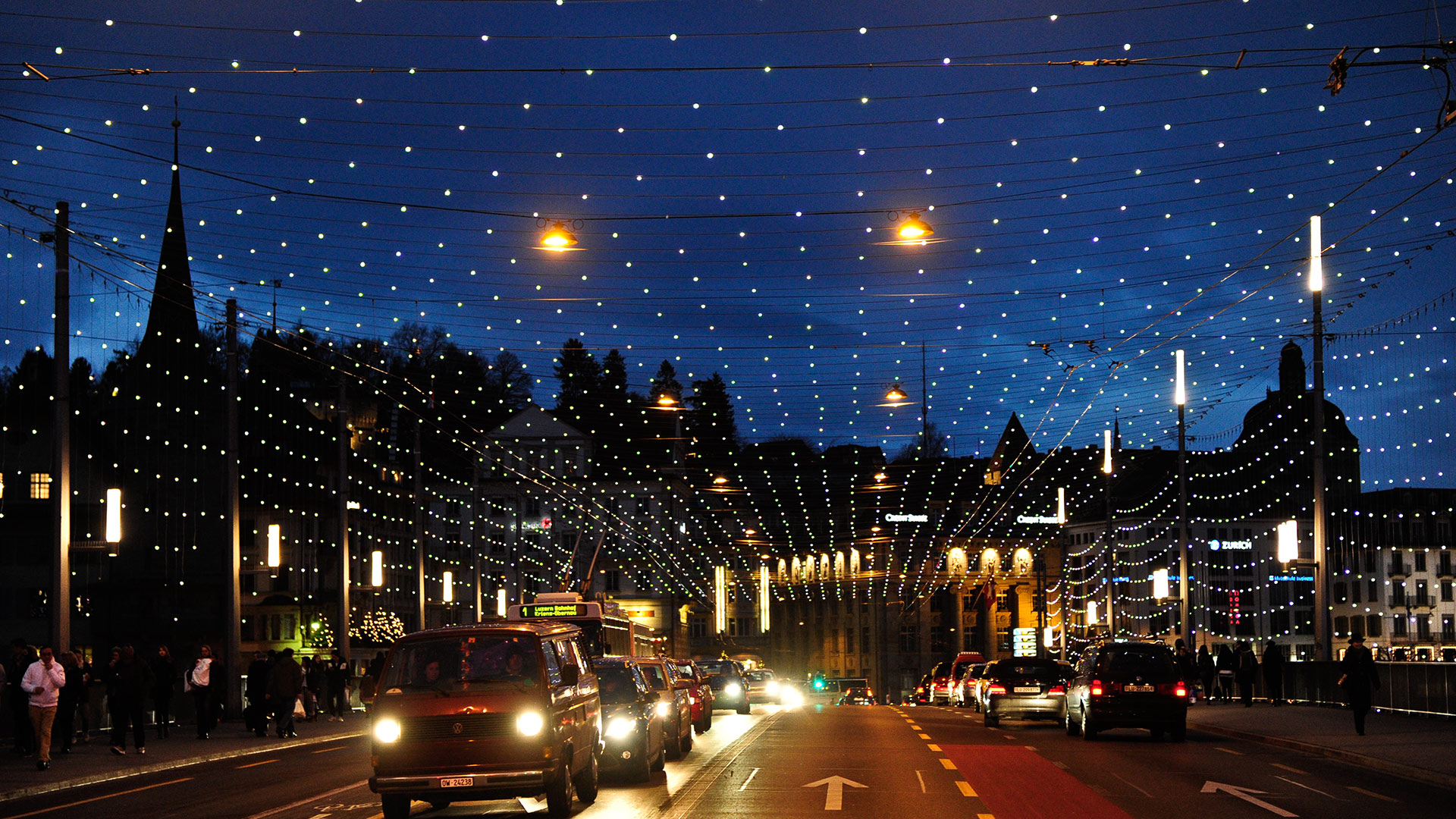 Zurich Bahnhofstrasse at night adorned with Artemide Diamante installation: a luminous canopy of white LED lights forming a starry sky over traffic