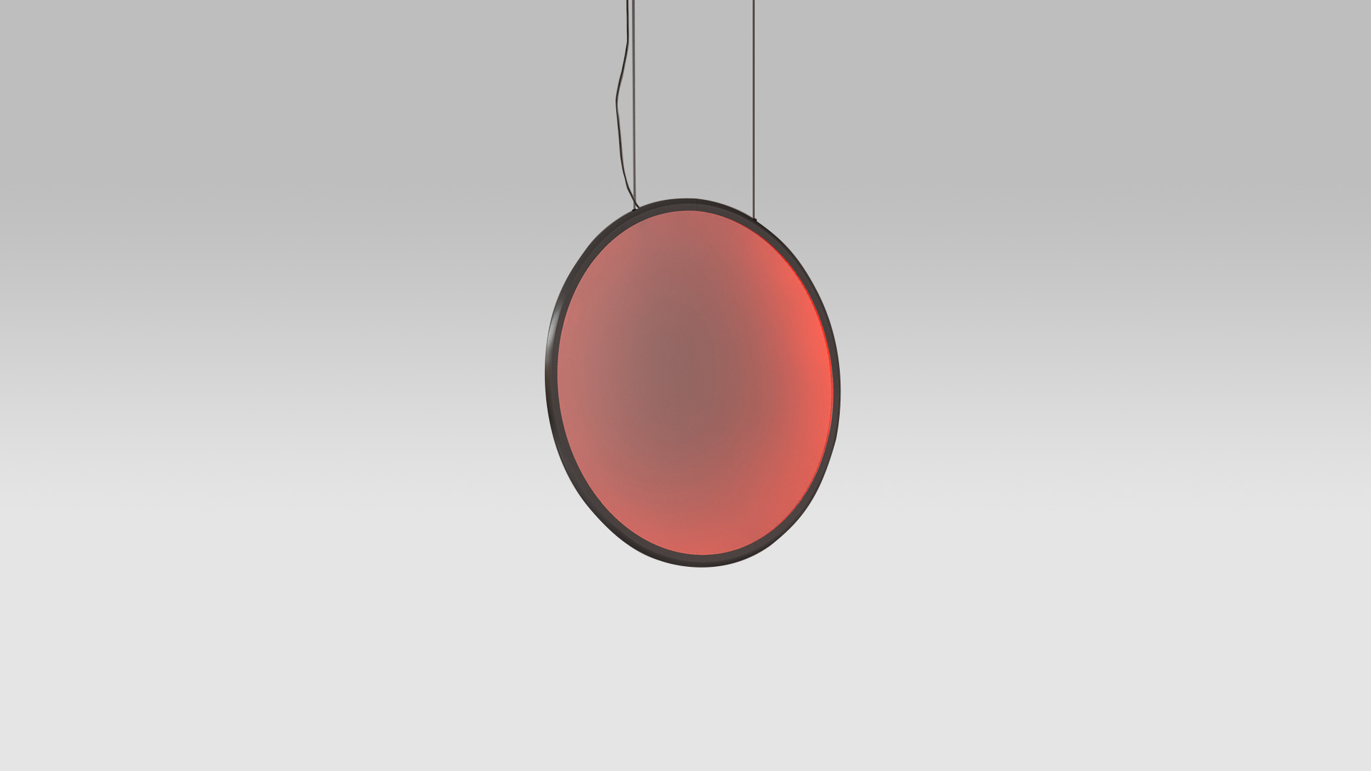 Artemide Discovery pendant lamp: large circular disc with dark frame emitting warm red gradient light, suspended by black cables