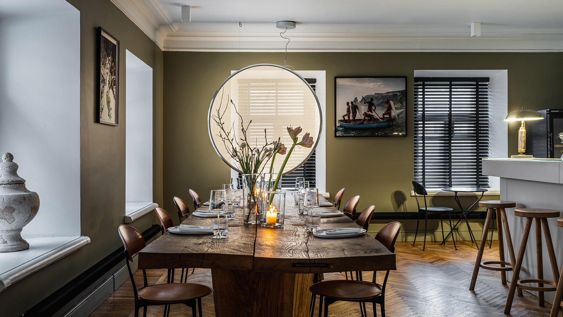 Artemide Discovery pendant lamp: large circular diffuser with white opal surface and dark grey metal ring, suspended by thin cables