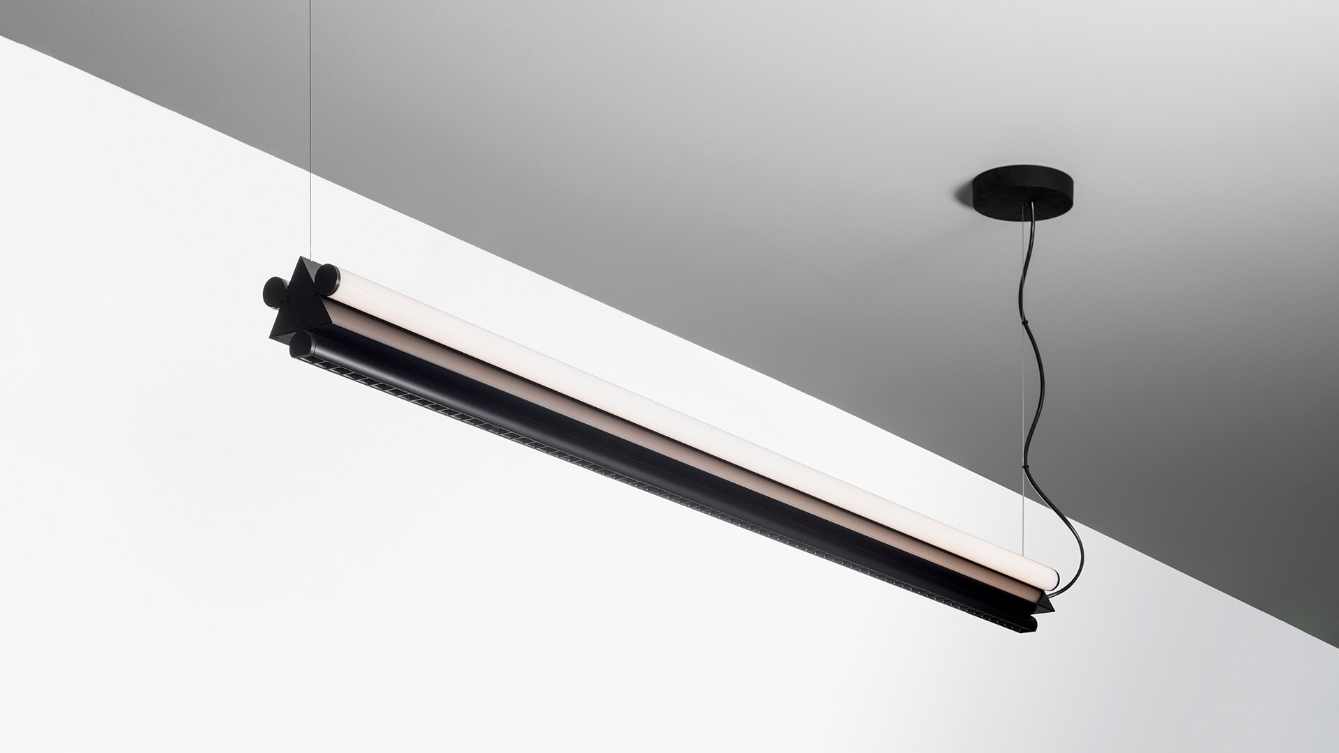 Artemide Dreispitz pendant lamp: elongated linear fixture in white and green with triangular dark green end caps, suspended from ceiling