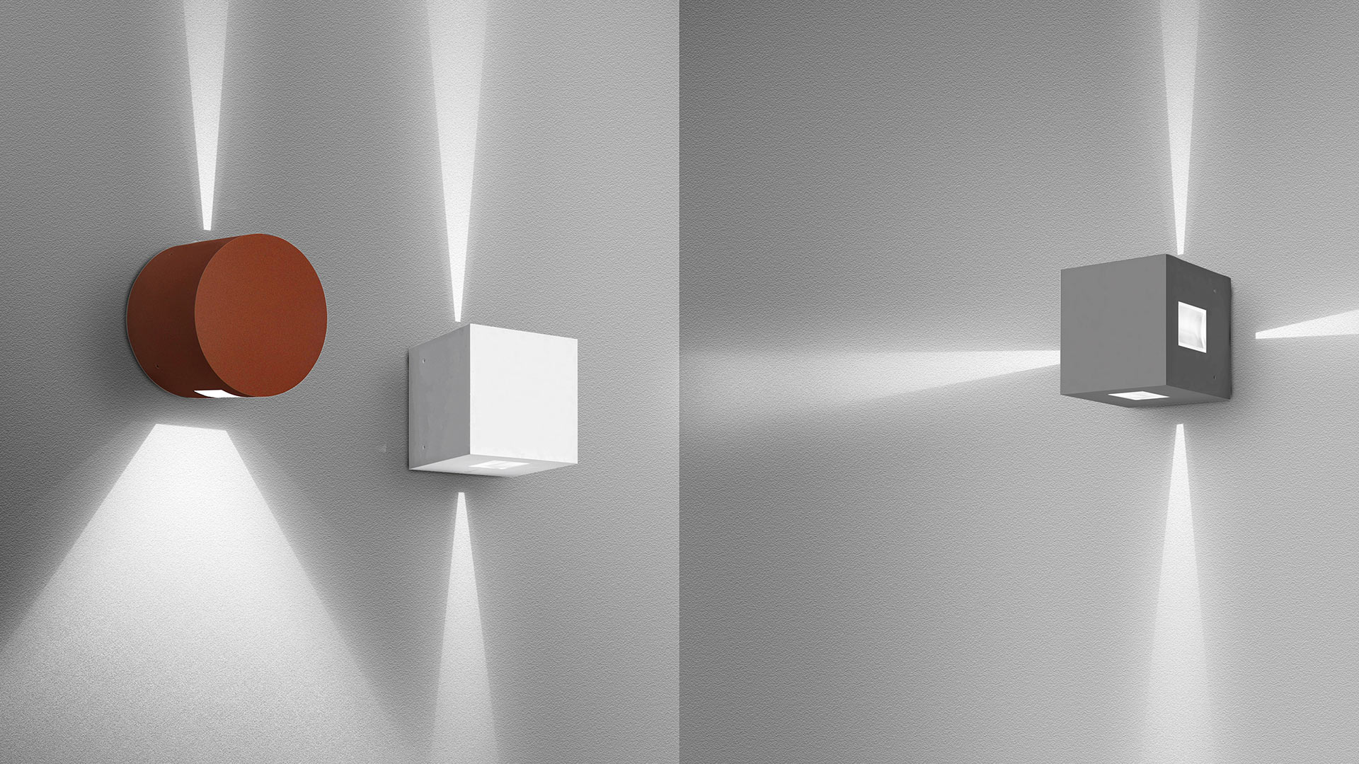 Three Artemide Effetto wall lights casting upward and downward beams: cylindrical terracotta, white cube, and grey cube versions