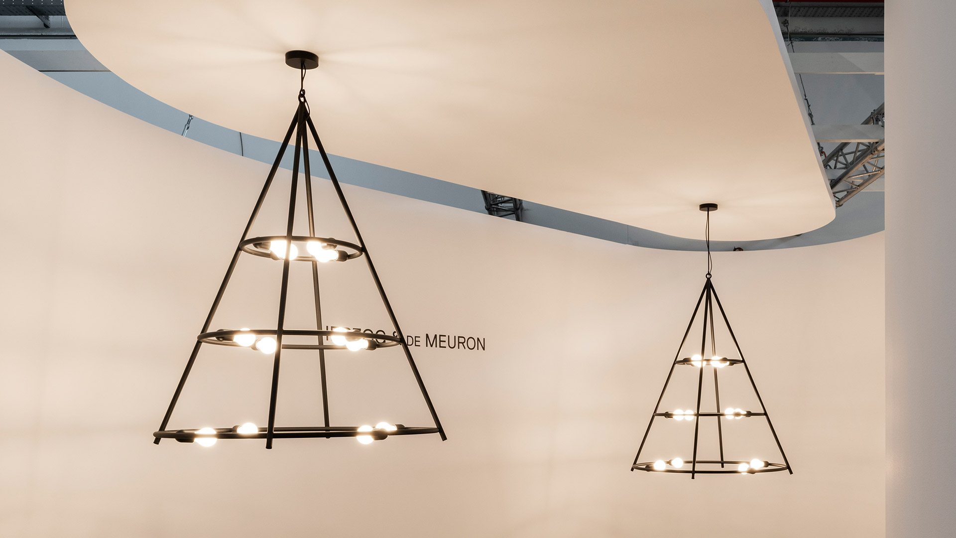 Artemide El Porís pendant chandelier: dark bronze geometric rings forming a cone shape with exposed globe bulbs arranged in a circle