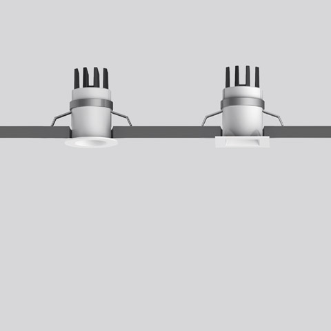 Two Artemide Everything 35 recessed ceiling spotlights with square white trim and heat-dissipating fins, mounted flush in ceiling