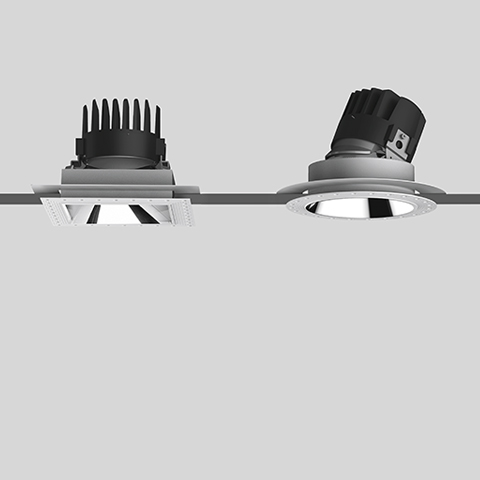 Two Artemide Everything recessed spotlights: left square trimless fixed downlight, right round adjustable tilting version, both in grey finish