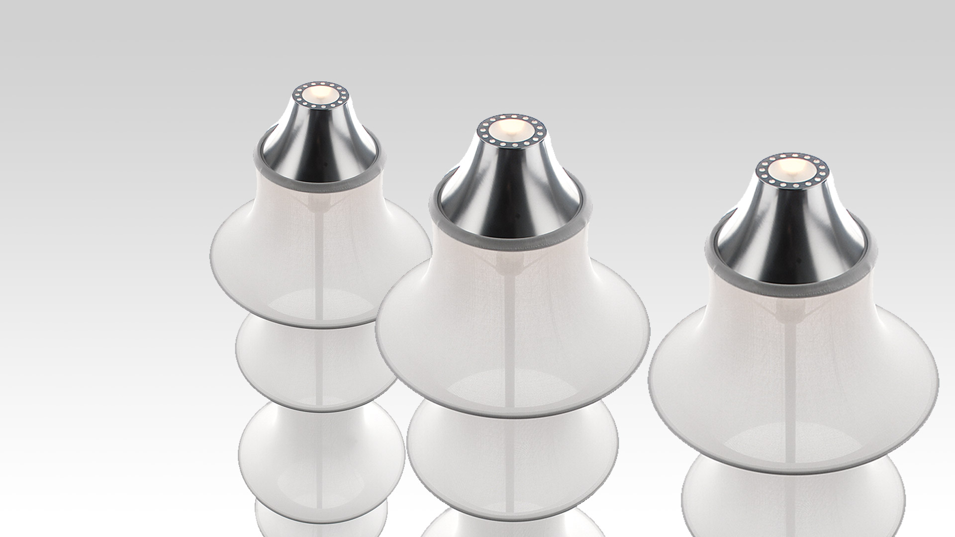 Three Artemide Falkland Terra table lamps with layered white diffusers and polished chrome tops housing LED light sources