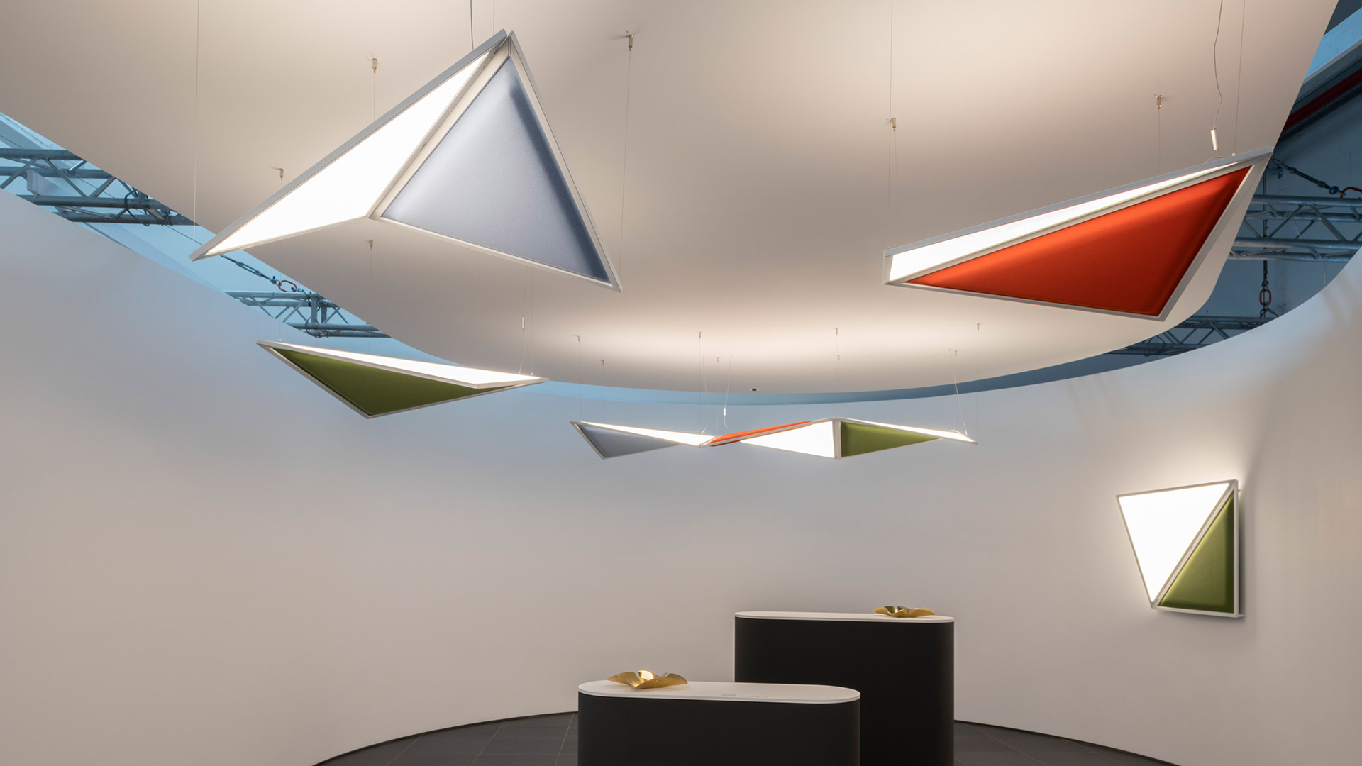 Artemide Flexia wall lamp: geometric triangular white luminous panel with olive green lower section in silver frame
