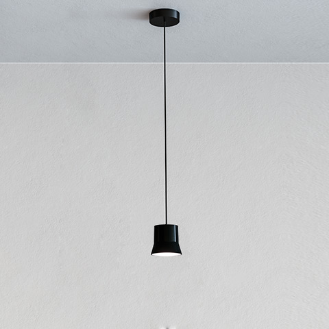 Artemide Giò Light suspension lamp in black, featuring a compact truncated cone shade hanging from a thin black cord on a white ceiling.