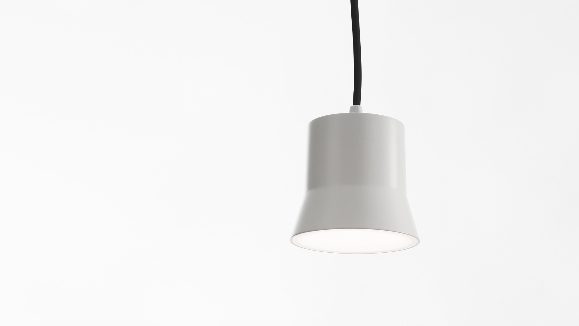 Artemide Giò Light suspension lamp: compact white ceramic bell-shaped shade hanging from a black cord, emitting soft downward light