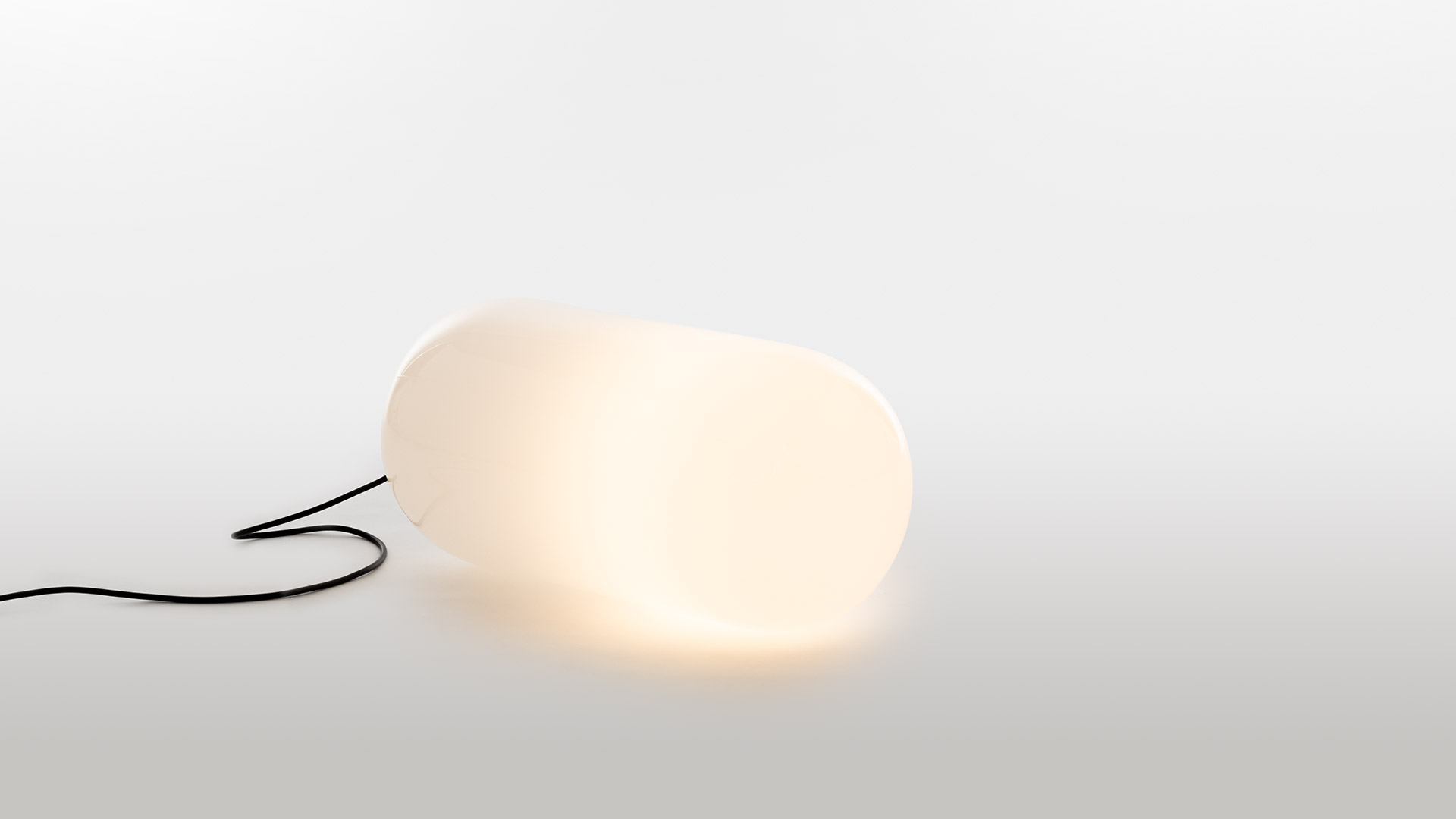 Artemide Gople Outdoor: white table lamp with organic glass shade on pedestal base and tall slim floor lamp pole, both in white