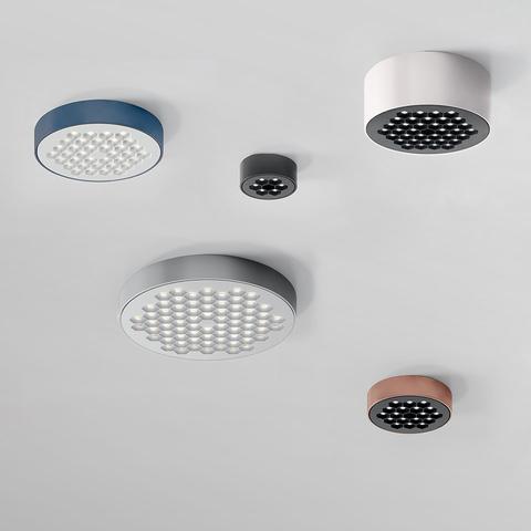 Five Artemide Helgoland LED ceiling lights in various sizes and colors: blue, white, grey, dark grey, and terracotta, with honeycomb diffusers