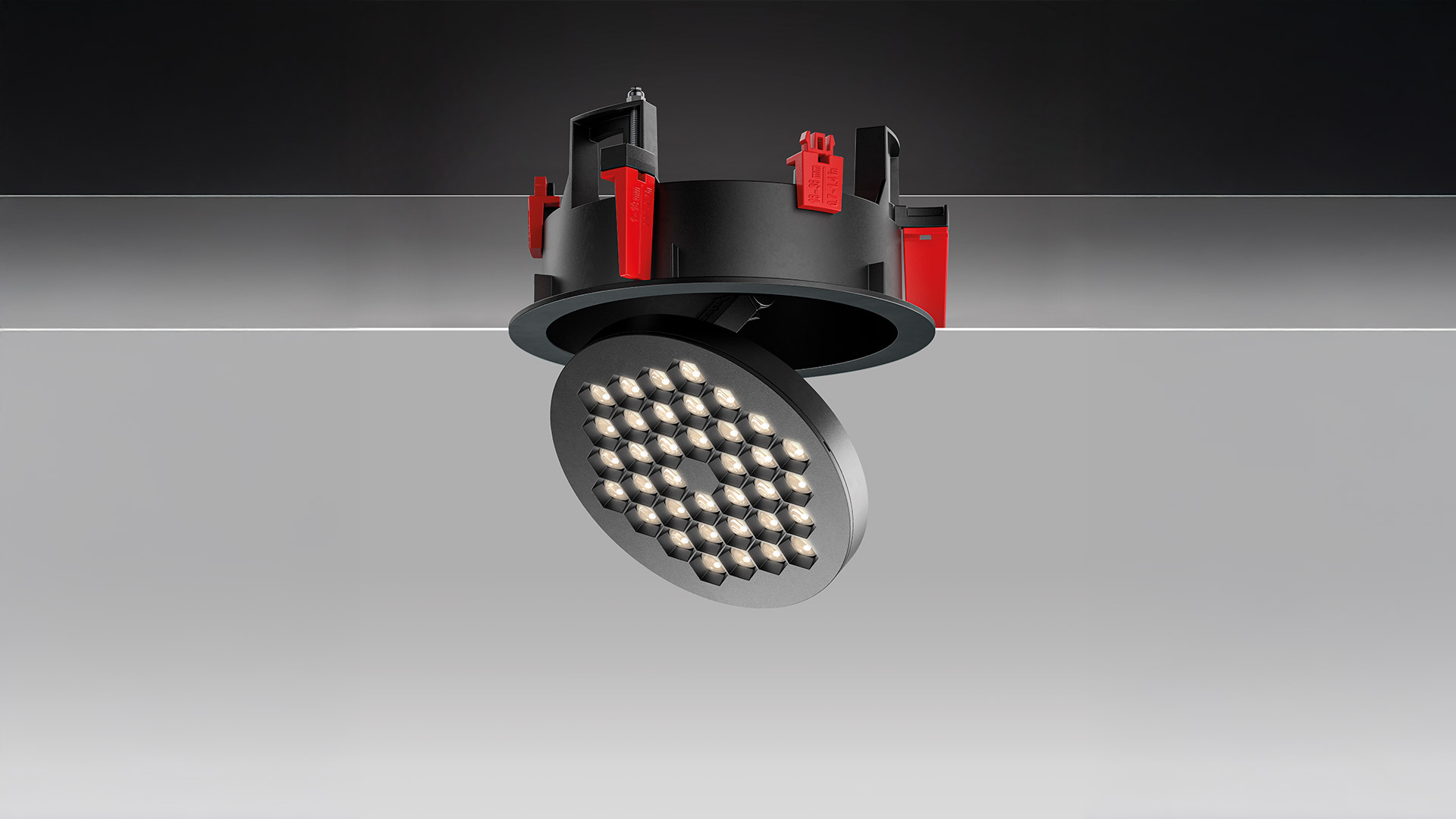 Two Artemide Helgoland LED recessed ceiling lights: one flush white fixed, one adjustable black tilted, both with honeycomb LED arrays