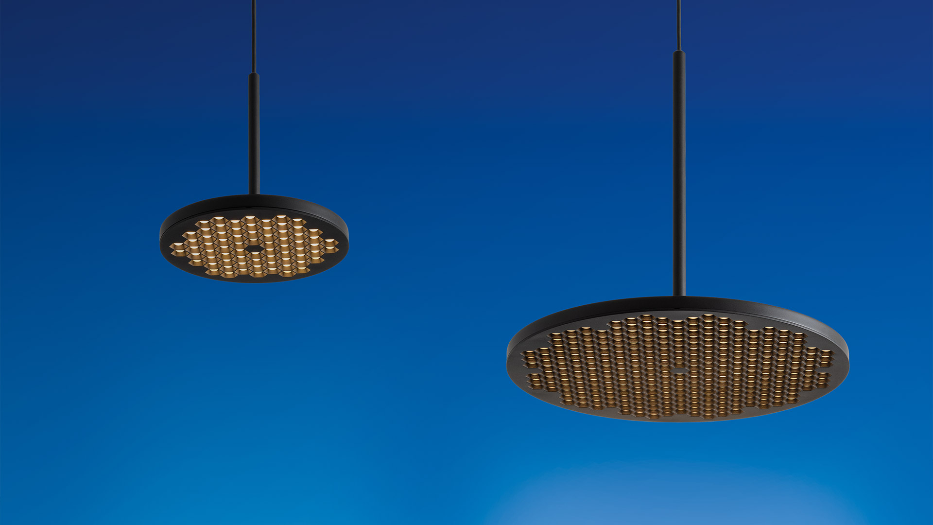 Artemide Helgoland floor lamp: slender black arc arm extending from cylindrical base, with oval gold mesh LED diffuser