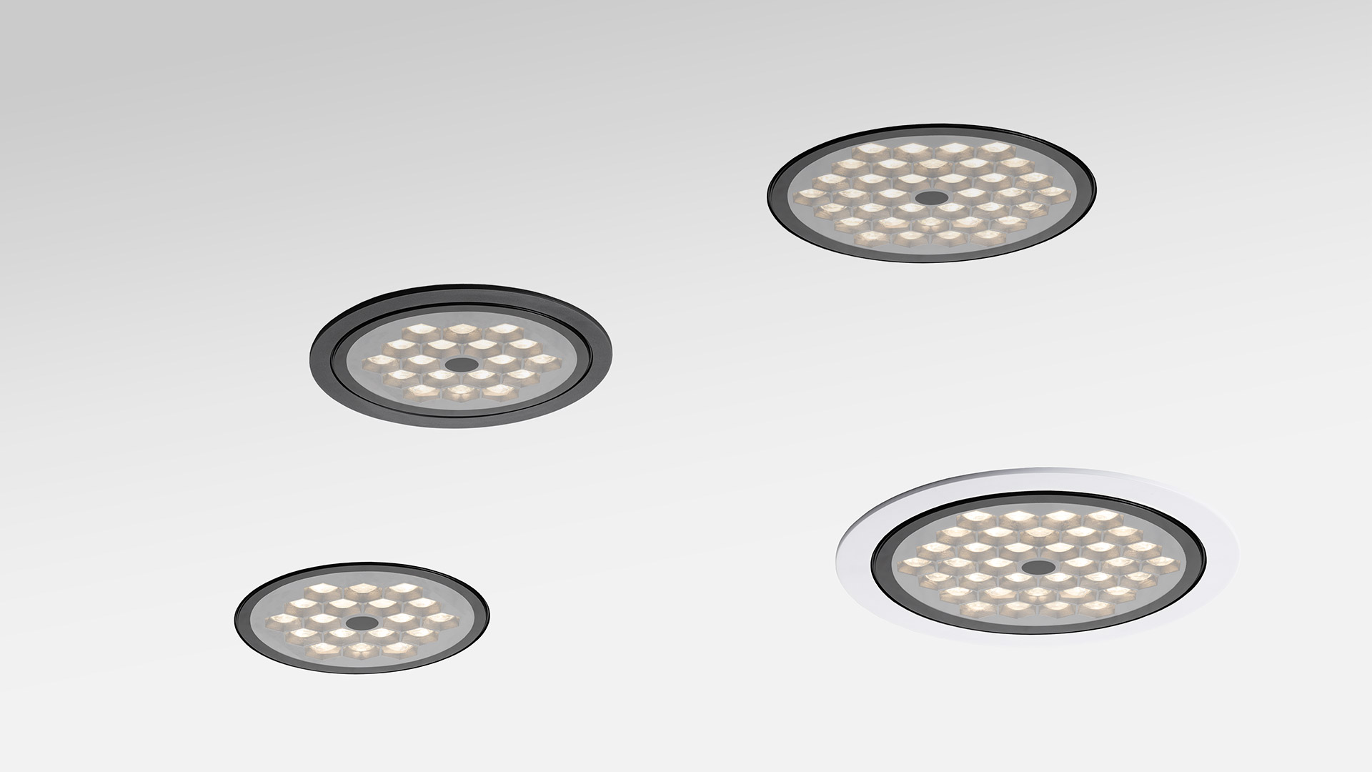 Four Artemide Helgoland IP44 recessed LED ceiling lights, two with dark trim and two with white trim, emitting warm diffused light