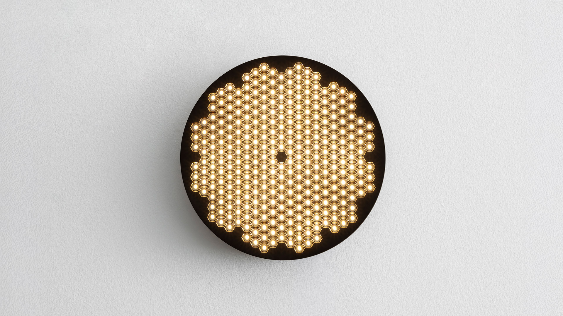 Artemide Helgoland recessed and surface-mounted ceiling lights in various sizes, featuring perforated dark diffusers and colored rings