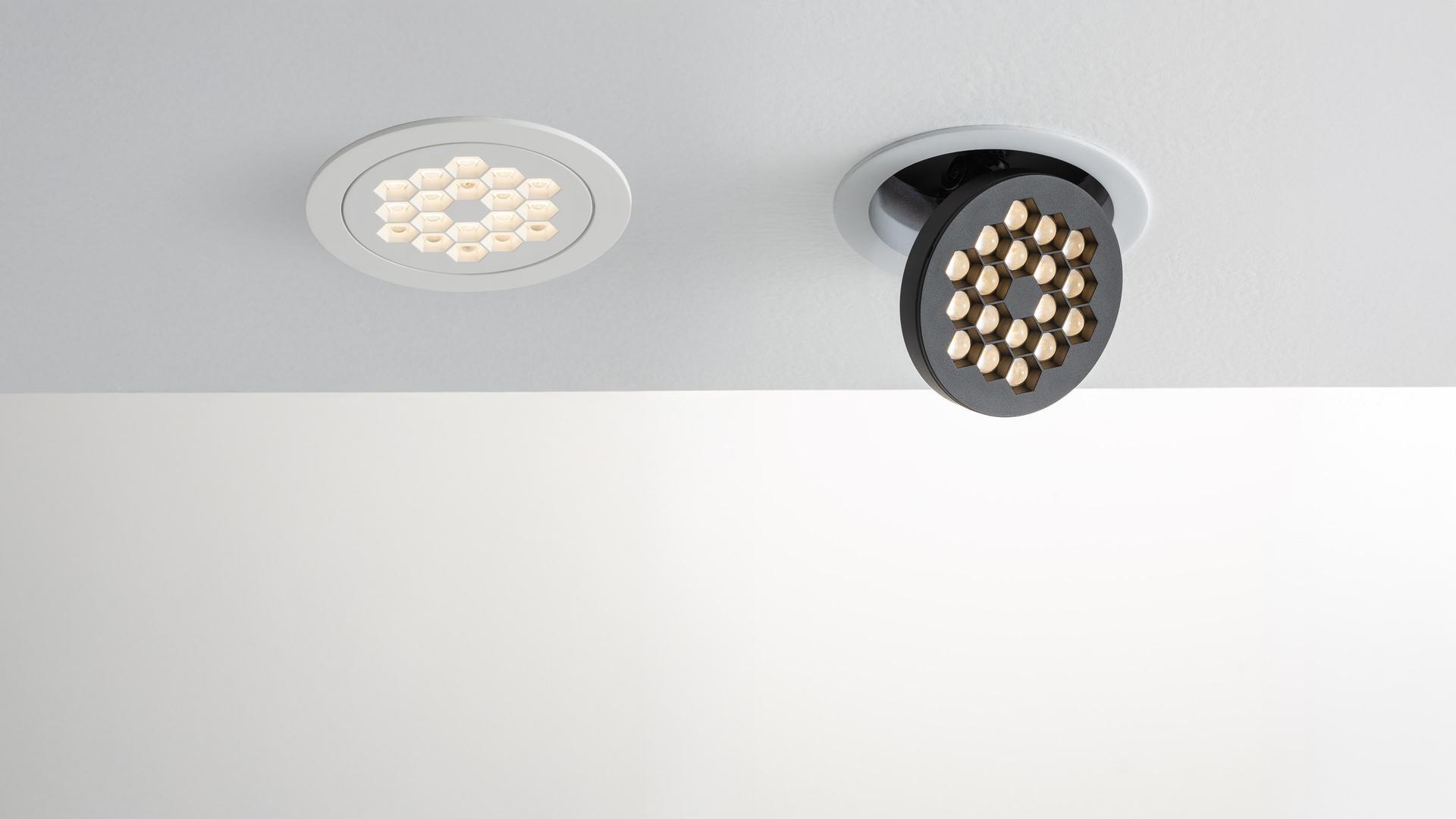 Artemide Helgoland Adjustable ceiling spotlight in matte black, cylindrical body with tilting LED head featuring multiple light points