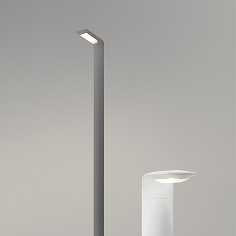 Artemide Hila outdoor LED luminaires: tall grey pole lamp with angled head and low white bollard light, both with rectangular LED modules