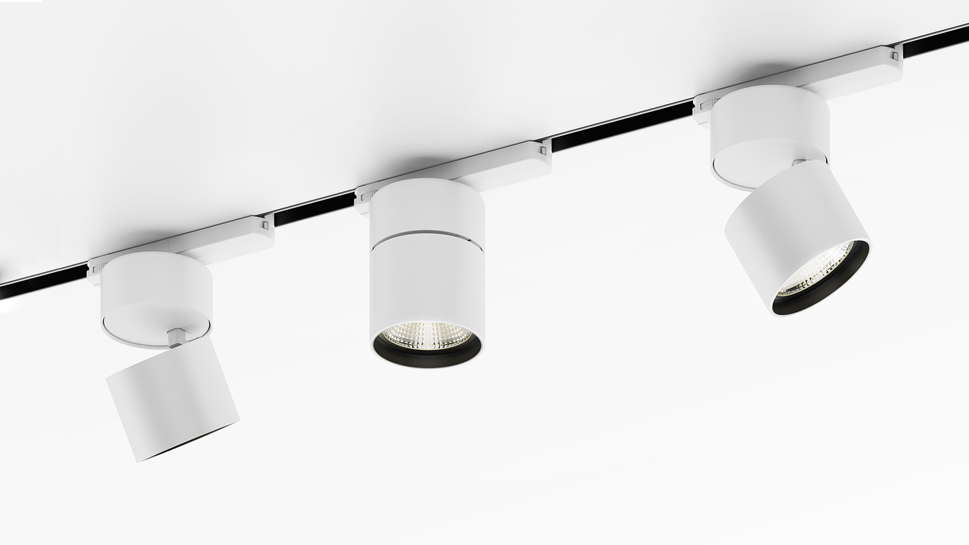 Two black Artemide Hoy cylindrical LED spotlights on a 3-phase track: left tilted spot, right fixed downward position