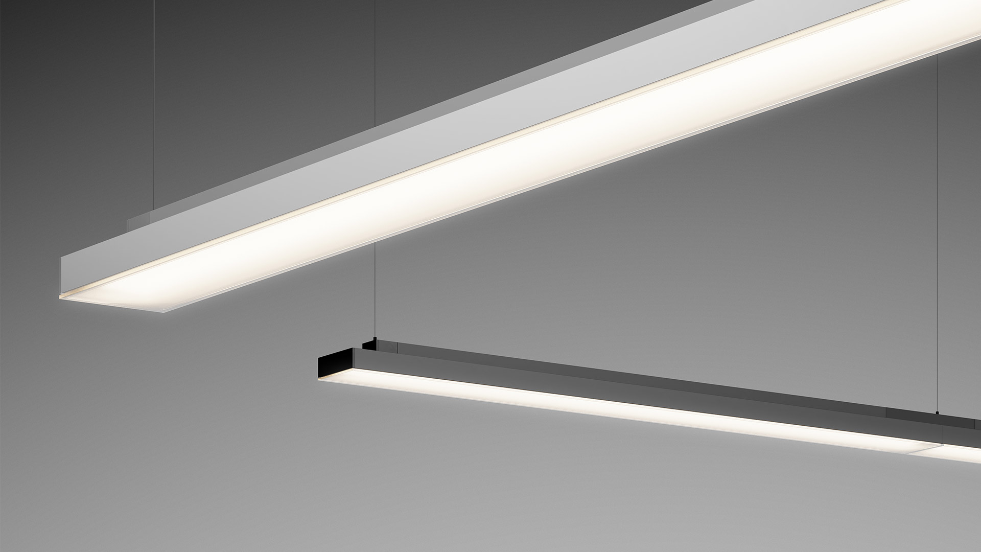 Three Artemide Hoy cylindrical pendant lights hang from ceiling alongside linear LED strips in a modern office space.