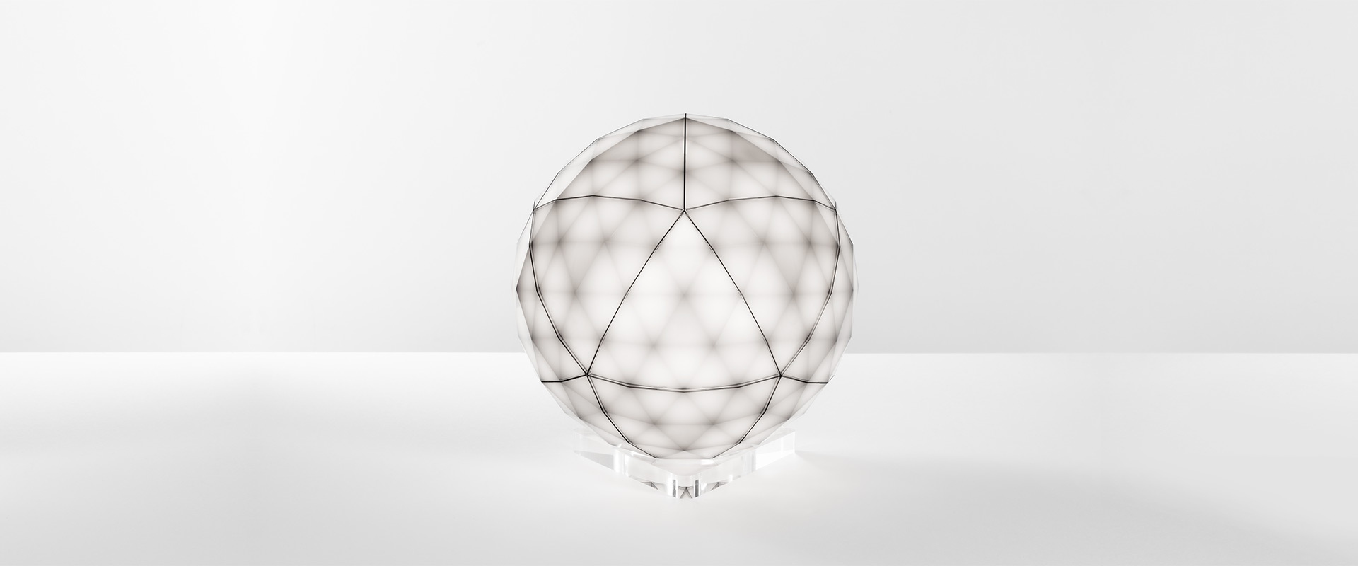 Artemide Huara lamp: black faceted spherical diffuser with geometric cuts on a transparent crystal base