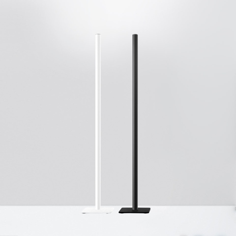 Artemide Ilio floor lamps: two ultra-slim vertical LED columns on square bases, one white and one black, emitting upward light