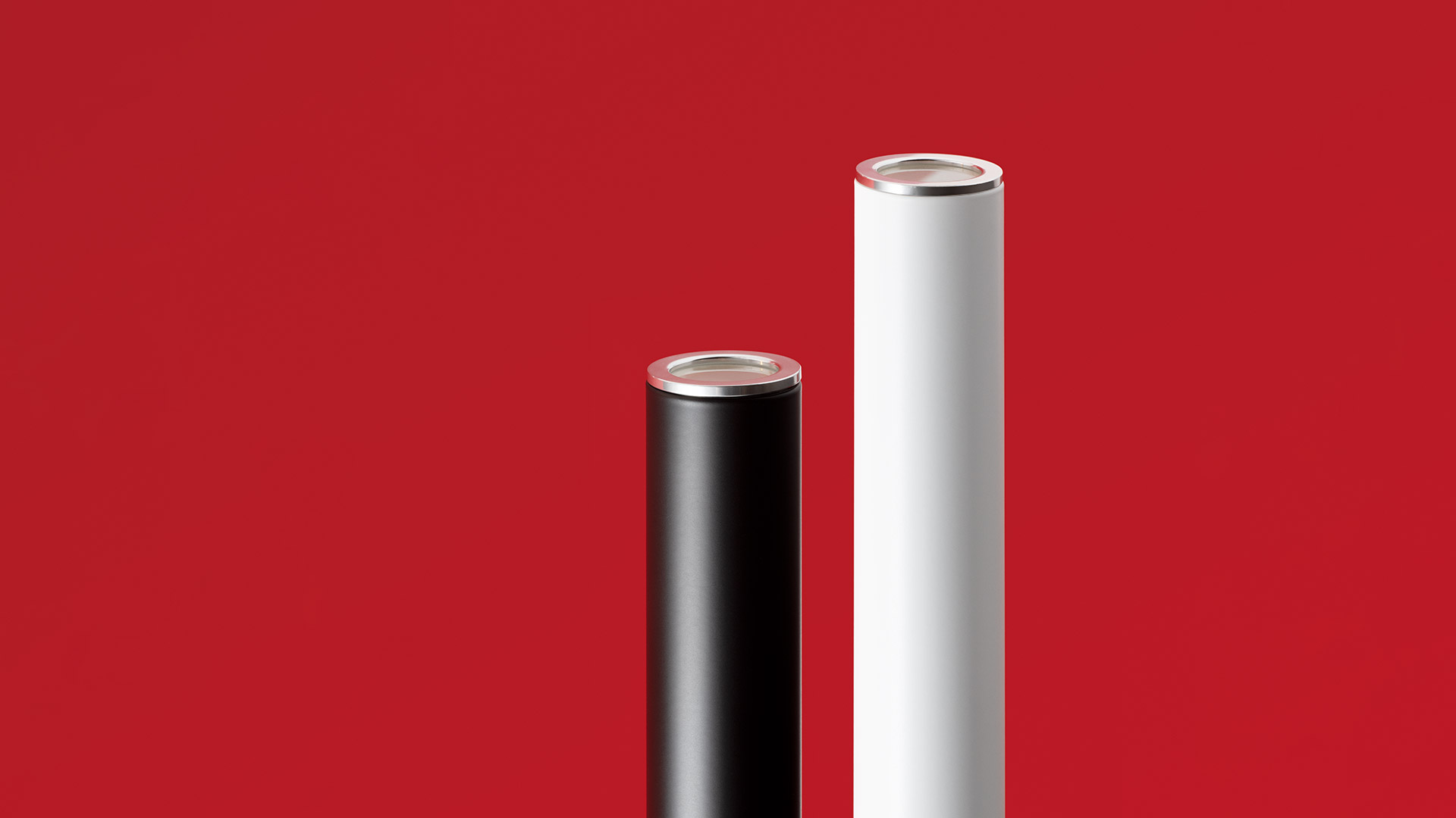 Two Artemide Ilio floor lamps in black: left is the Ilio, right is the smaller Ilio Mini, both with sleek cylindrical stems