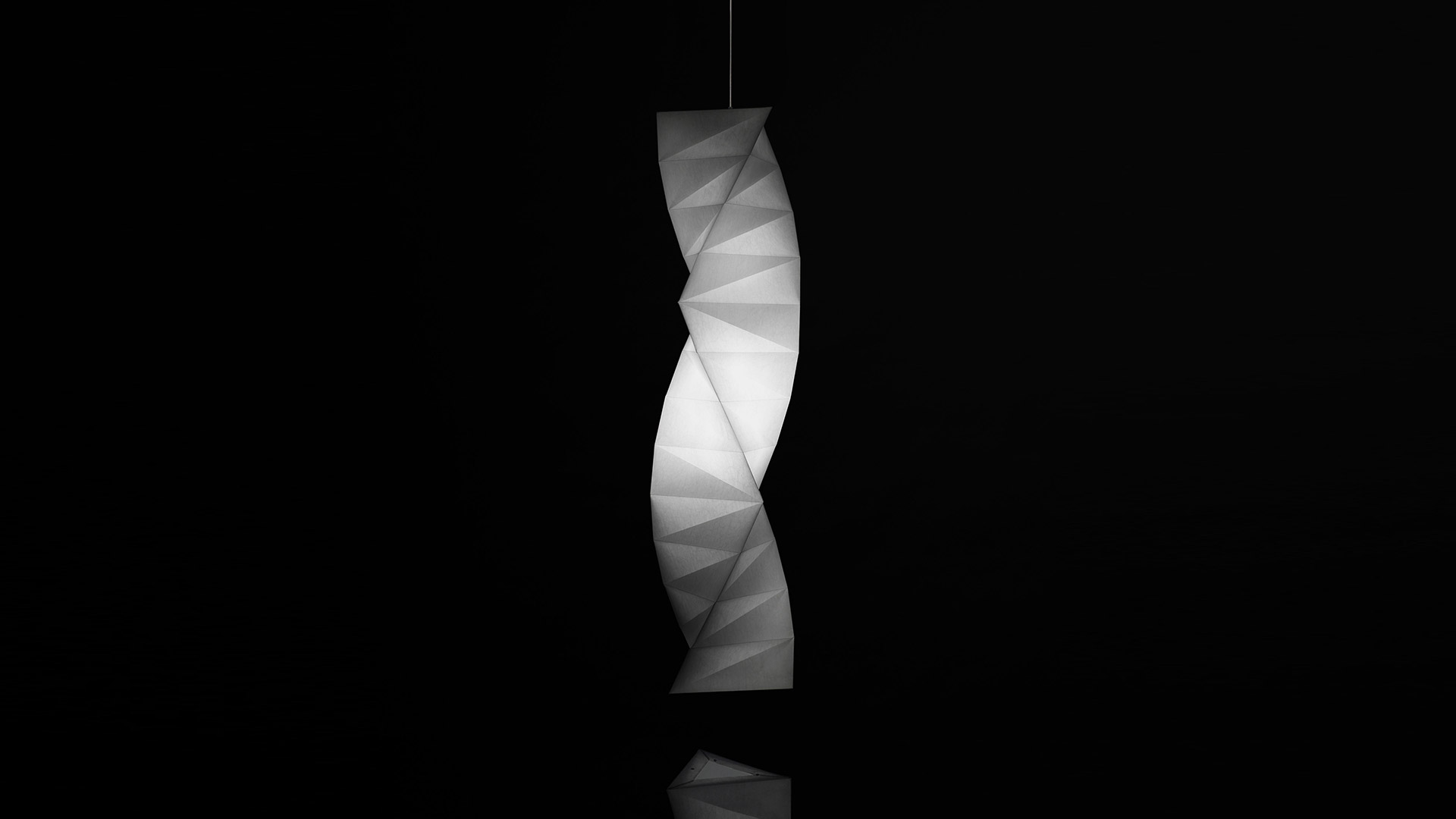 Artemide In-Ei Issey Miyake Tatsuno-Otoshigo pendant lamp: twisted origami-inspired white diffuser glowing against dark background