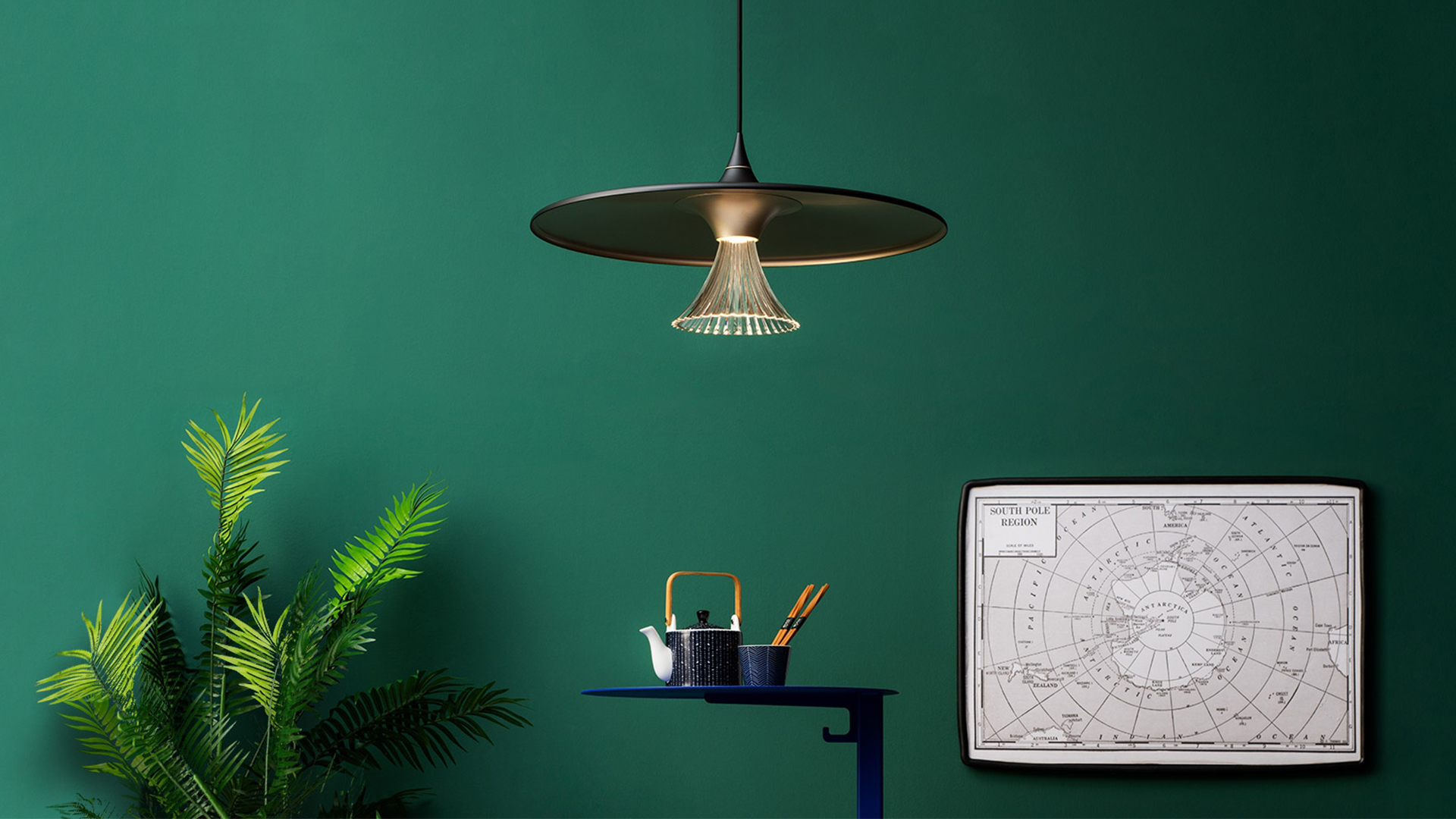 Ipno suspension lamp by Artemide: wide black and gold disc shade with elegant brass fiber light curtain hanging beneath
