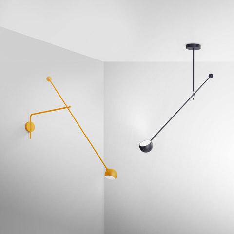 Two Artemide Ixa lamps: yellow wall version with adjustable arms and dome shade; black ceiling version with counterbalance rod