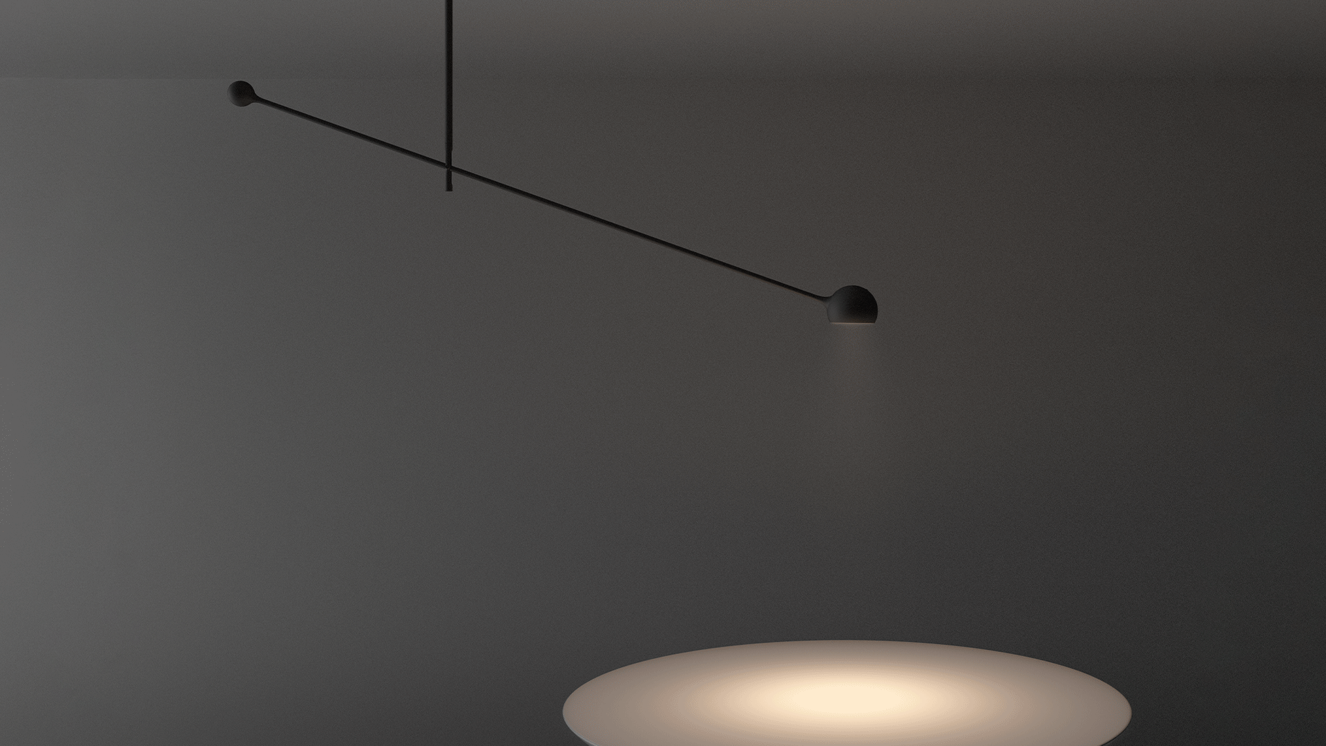 Artemide Ixa white desk lamp with spherical head on curved arm, placed beside a vintage yellow typewriter on a blue surface