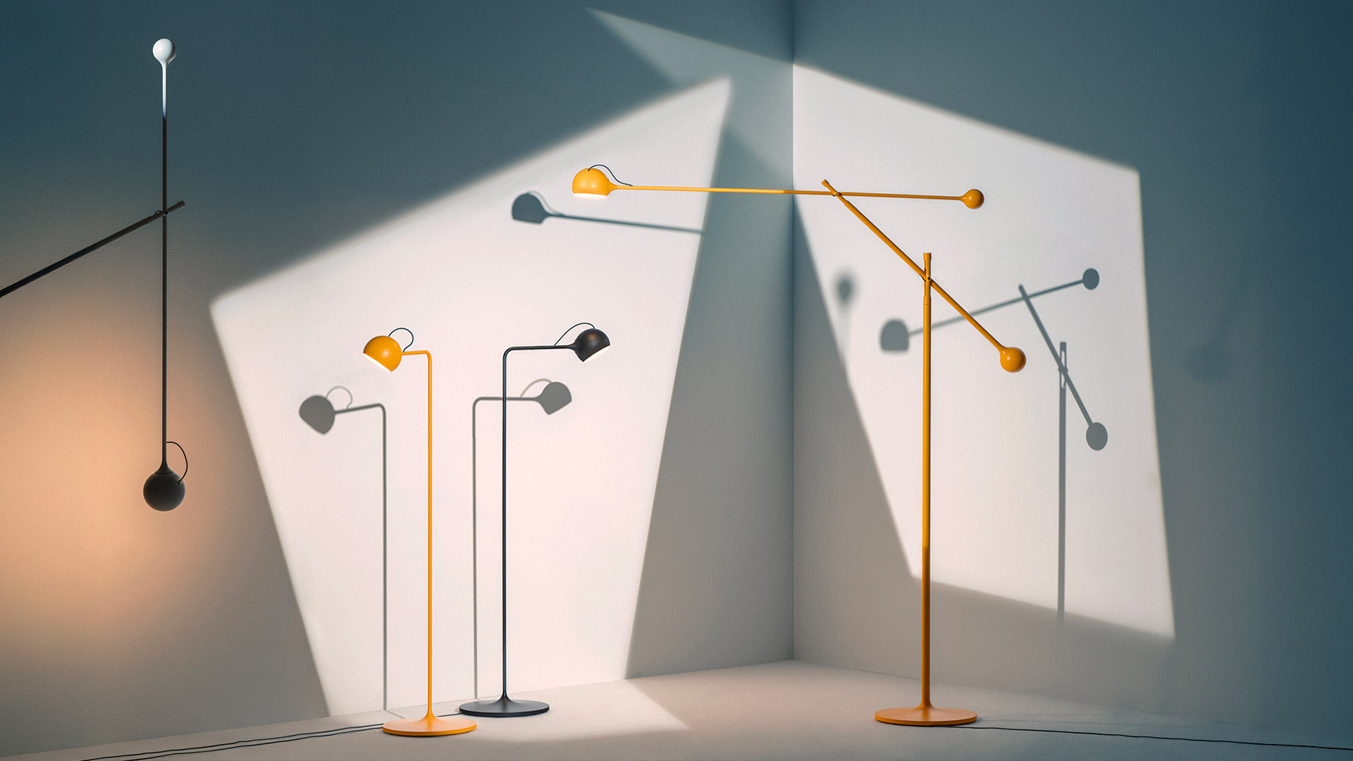 Two Artemide Ixa floor lamps on a white surface: left in white, right in black, both with slim stems and adjustable spherical heads