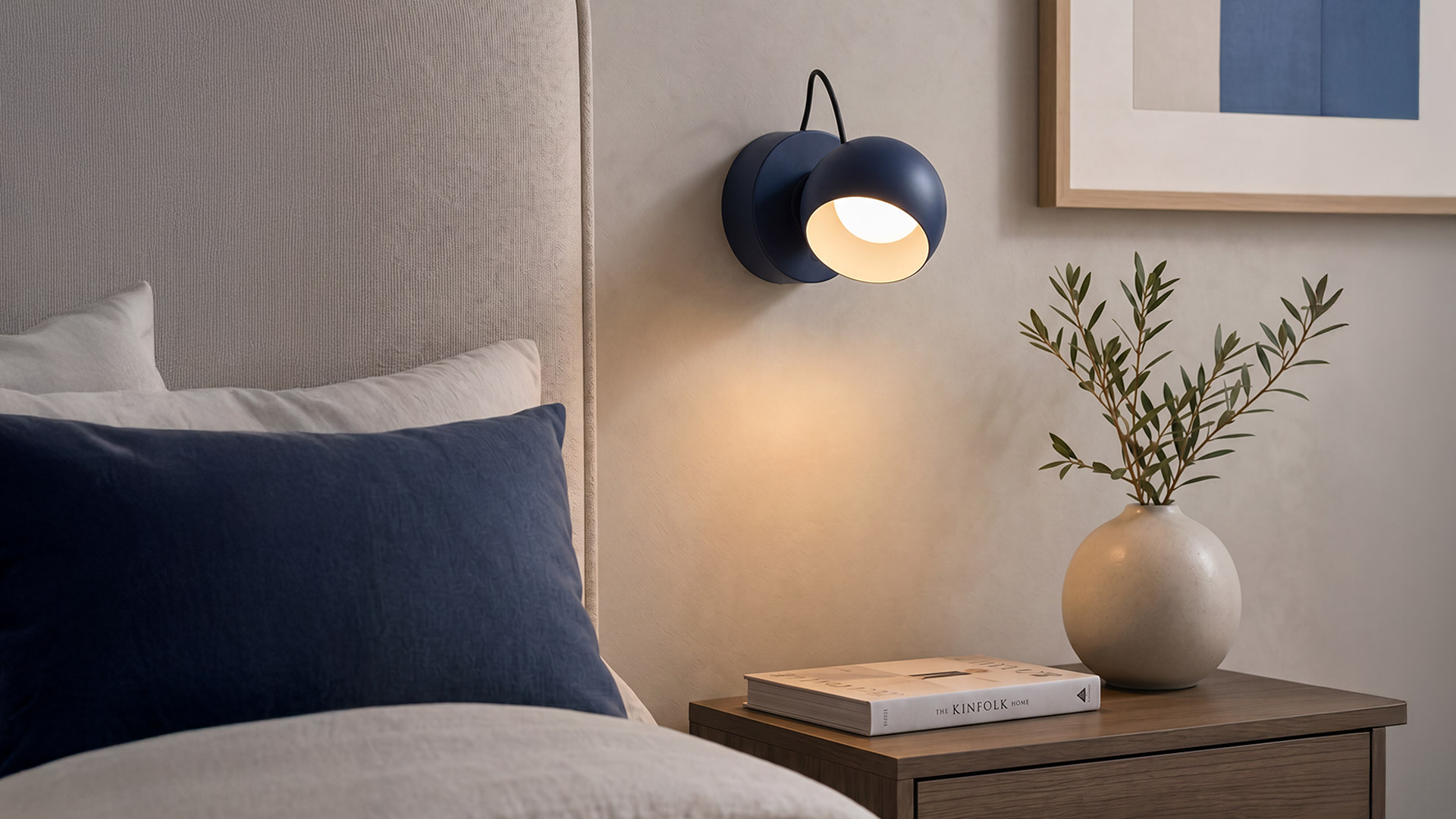 Artemide Ixa lamps in white and yellow, shown wall-mounted and handheld, featuring circular heads on flexible black cables